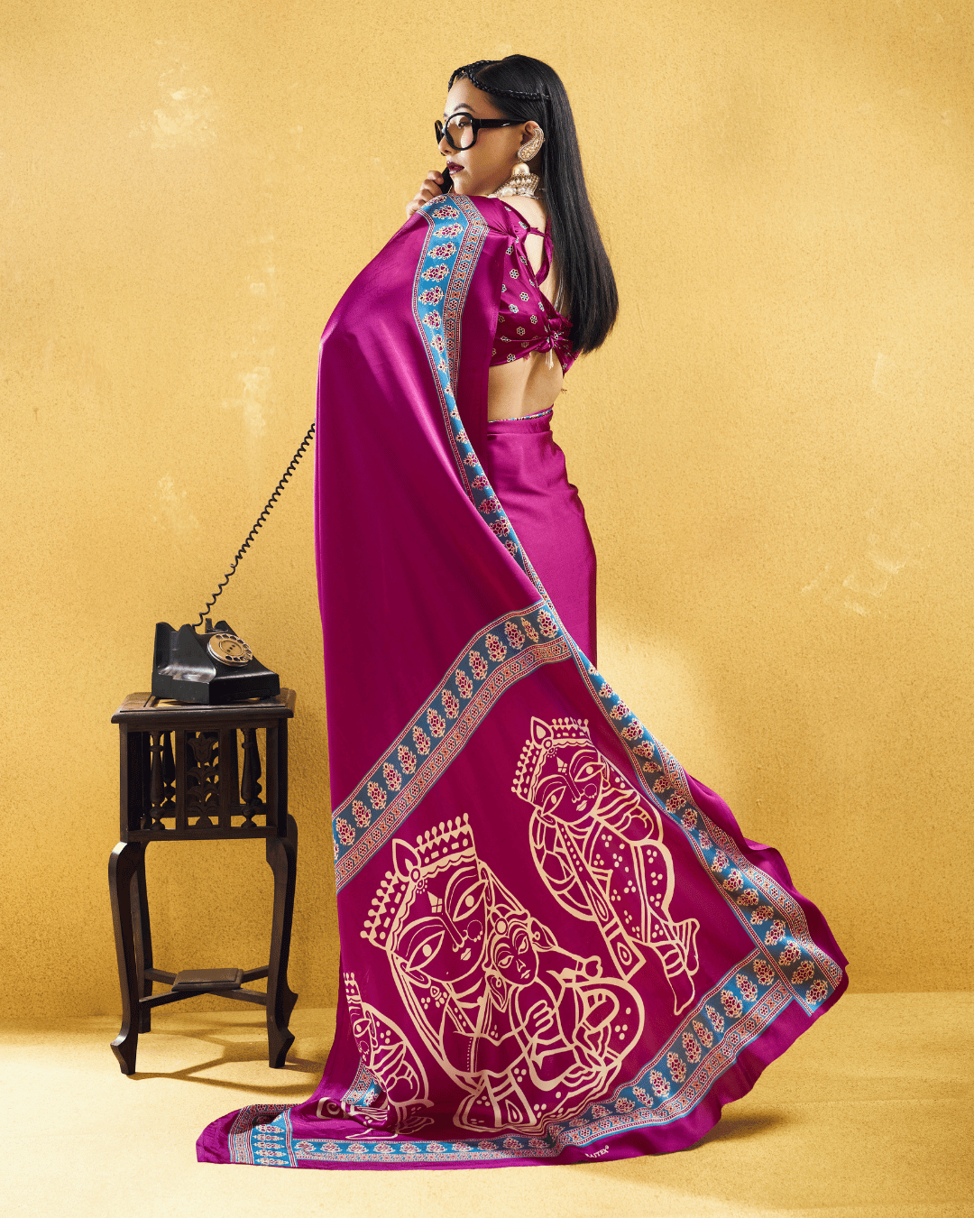 Back view showcasing the smooth drape of the magenta body, contrasting blue border trim, and sweeping printed pallu of the pre-draped pocket saree.