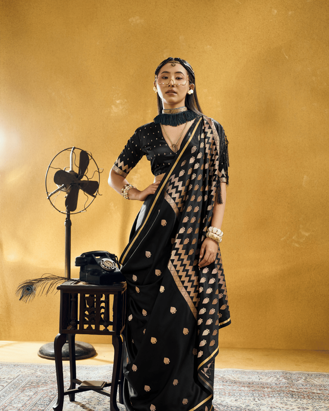 Full-length portrait of a model wearing the Black Chevron powerloom silk ready-to-wear pocket saree with pre-stitched pleats.