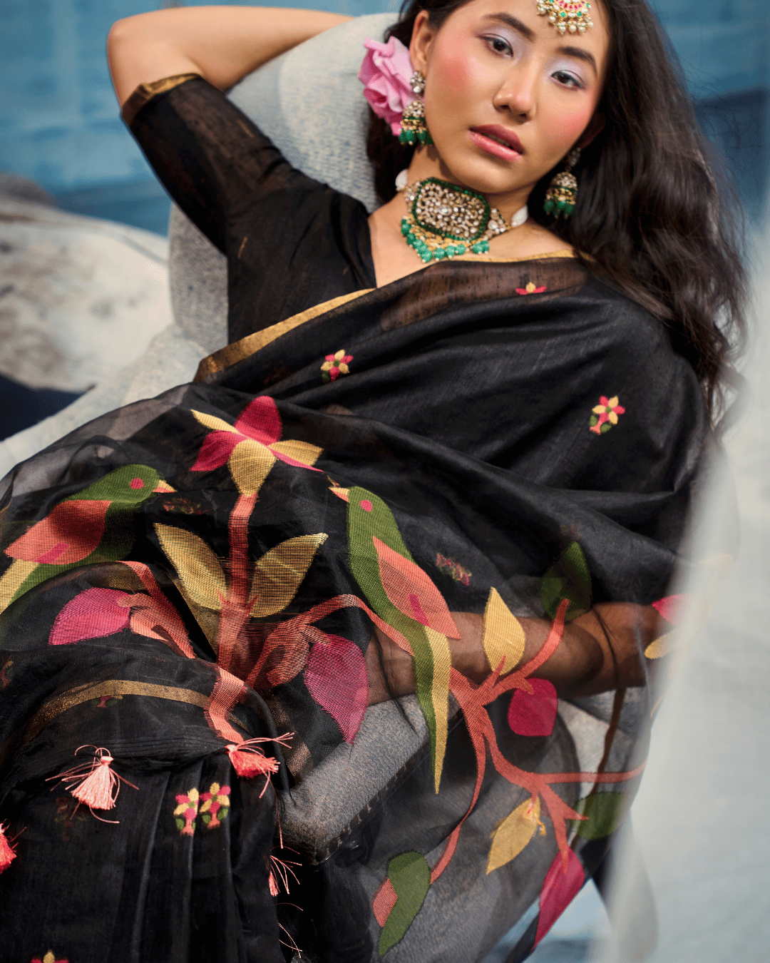 Close-up shot emphasizing the munga-cotton texture, small multicolored body motifs, and the detailed pink, olive green, and gold bird-and-leaf artwork across the translucent pallu.