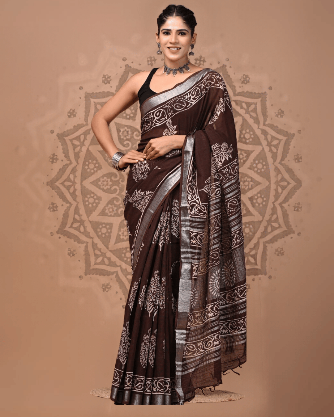 Chocolate-brown linen ready-to-wear pocket saree with beige tree-like motifs, ornamental patterned bands, a silver-grey border, striped pallu, and dark tassels.