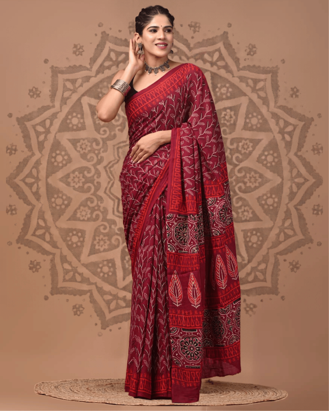 Wine-toned Mul Cotton ready-to-wear pocket saree featuring fine ivory branch motifs, a red geometric border, and a patterned pallu with floral medallions and leaf designs.