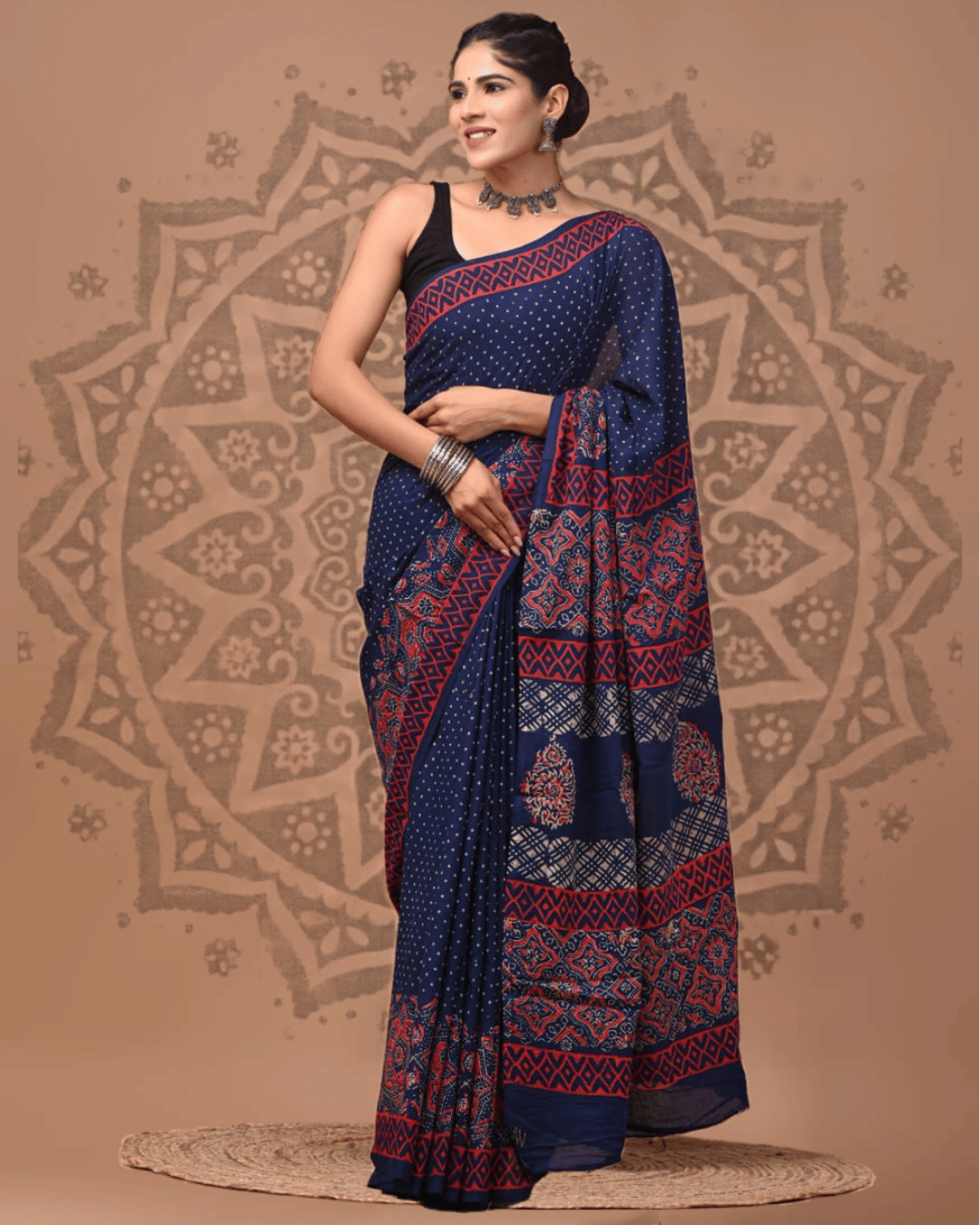 Navy blue Mul Cotton ready to wear pocket saree with tiny ivory dots, a red diamond-patterned border, and a pallu featuring red, ivory and blue geometric motifs, lattice bands and floral medallions.