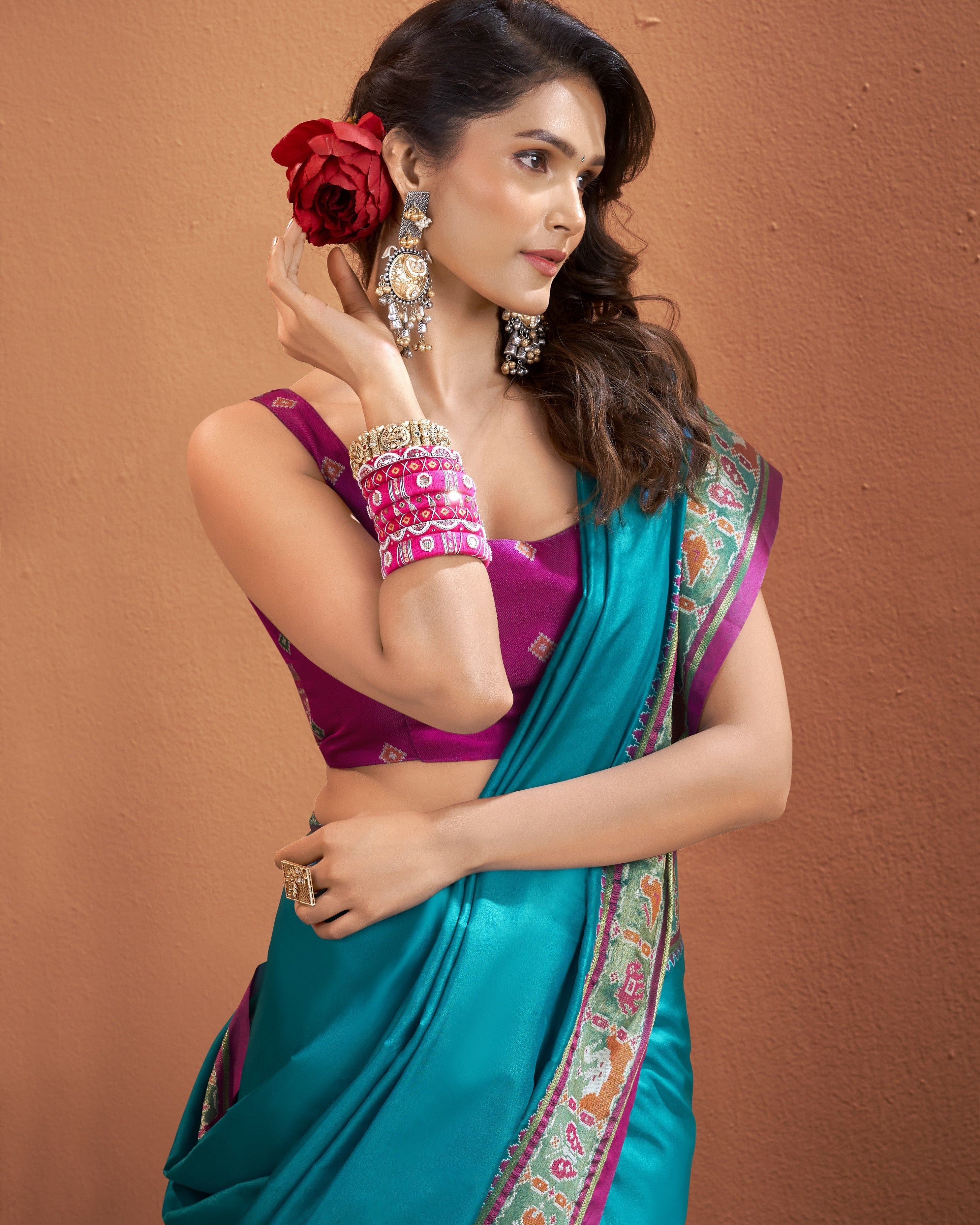 Teal blue Patola Silk ready-to-wear pocket saree with pink border featuring traditional details