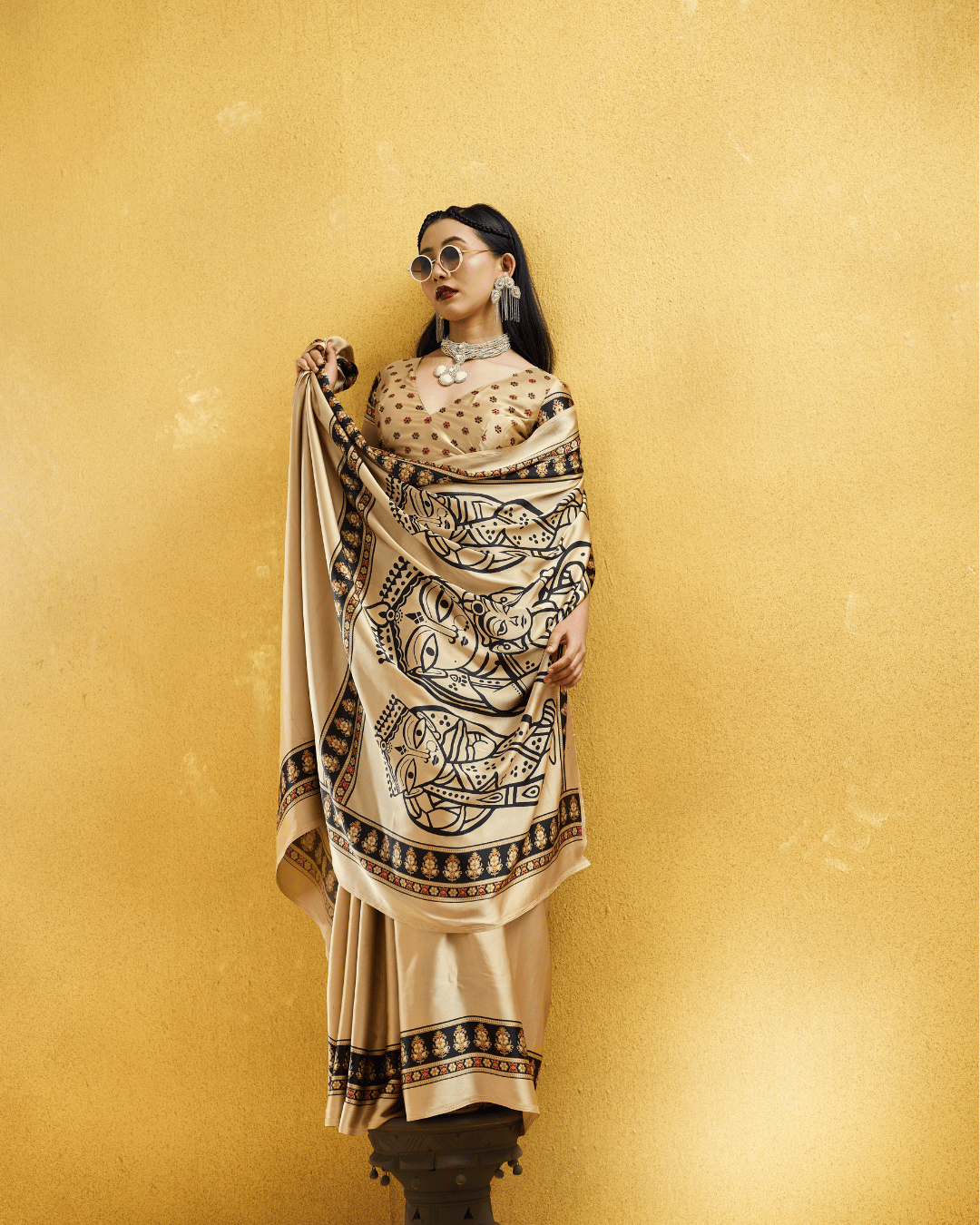 Model posing with the pre-stitched saree draped across the shoulder to showcase the statement pallu artwork.