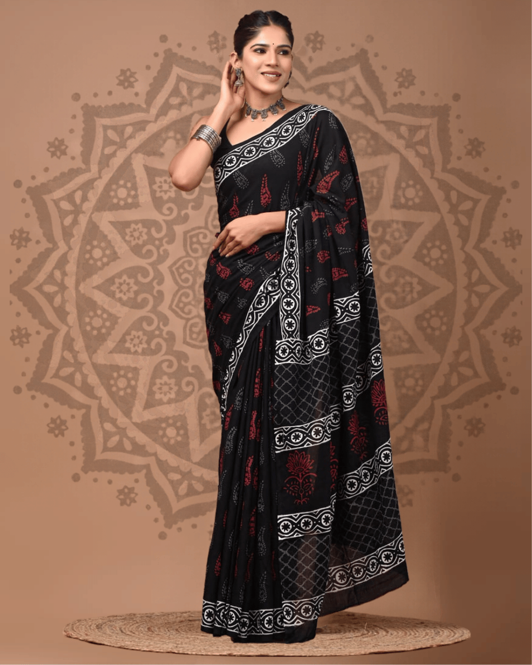 Black Mul Cotton ready-to-wear pocket saree with rust-red botanical motifs, white circular floral borders and a diamond-lattice pallu.