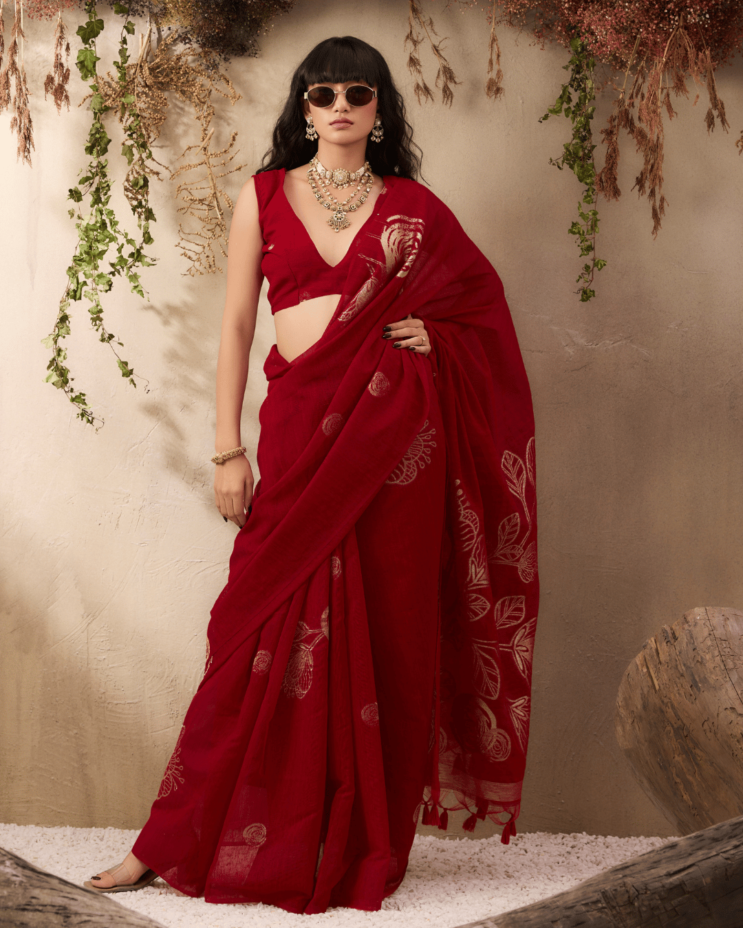 Fron shot of the model wearing the deep ruby-red pocket saree showing the elegant drape and statement gold-patterned floral pallu.