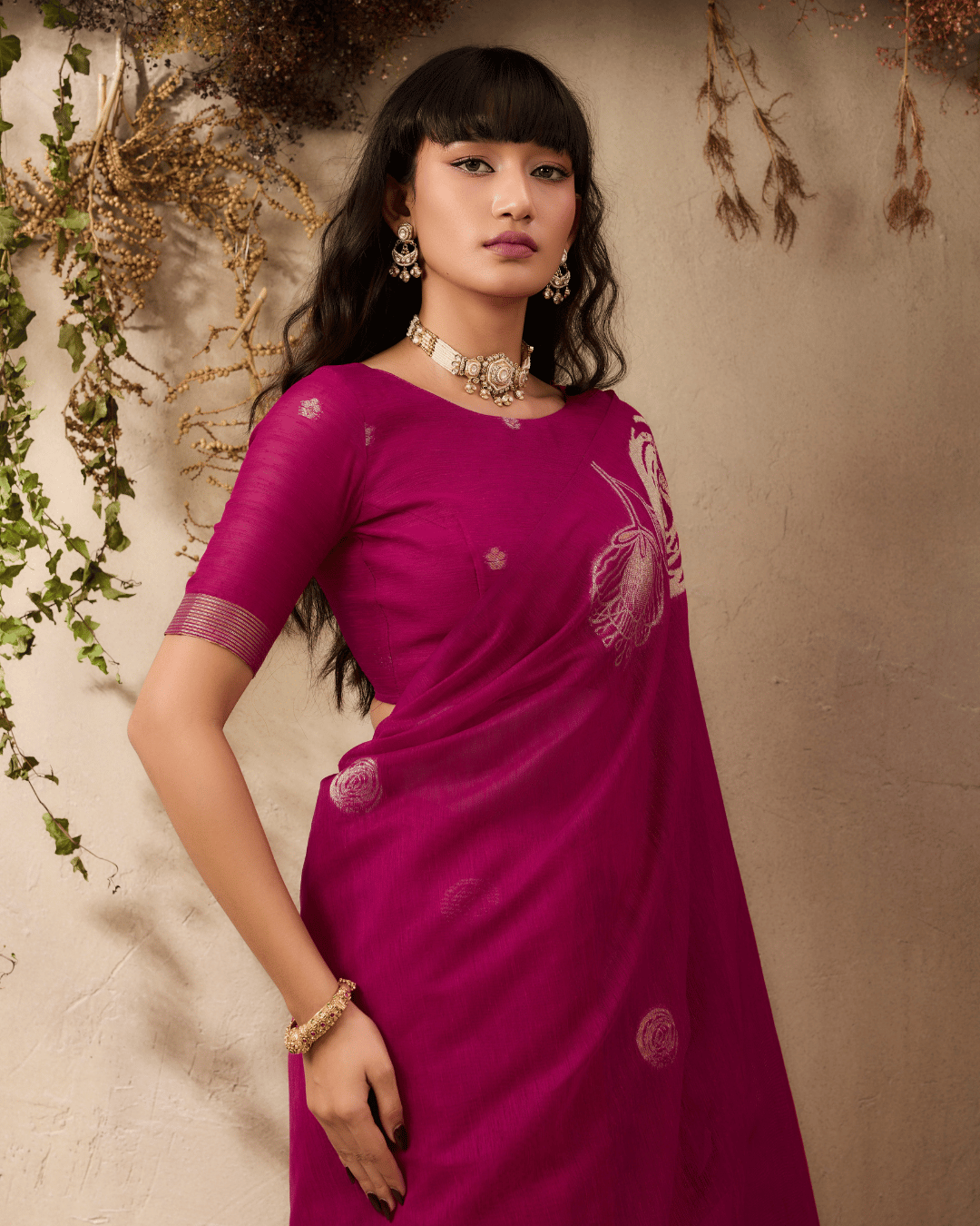 Close-up shot focusing on the fine gold line floral design of the vine and verse pre-stitched pocket saree.