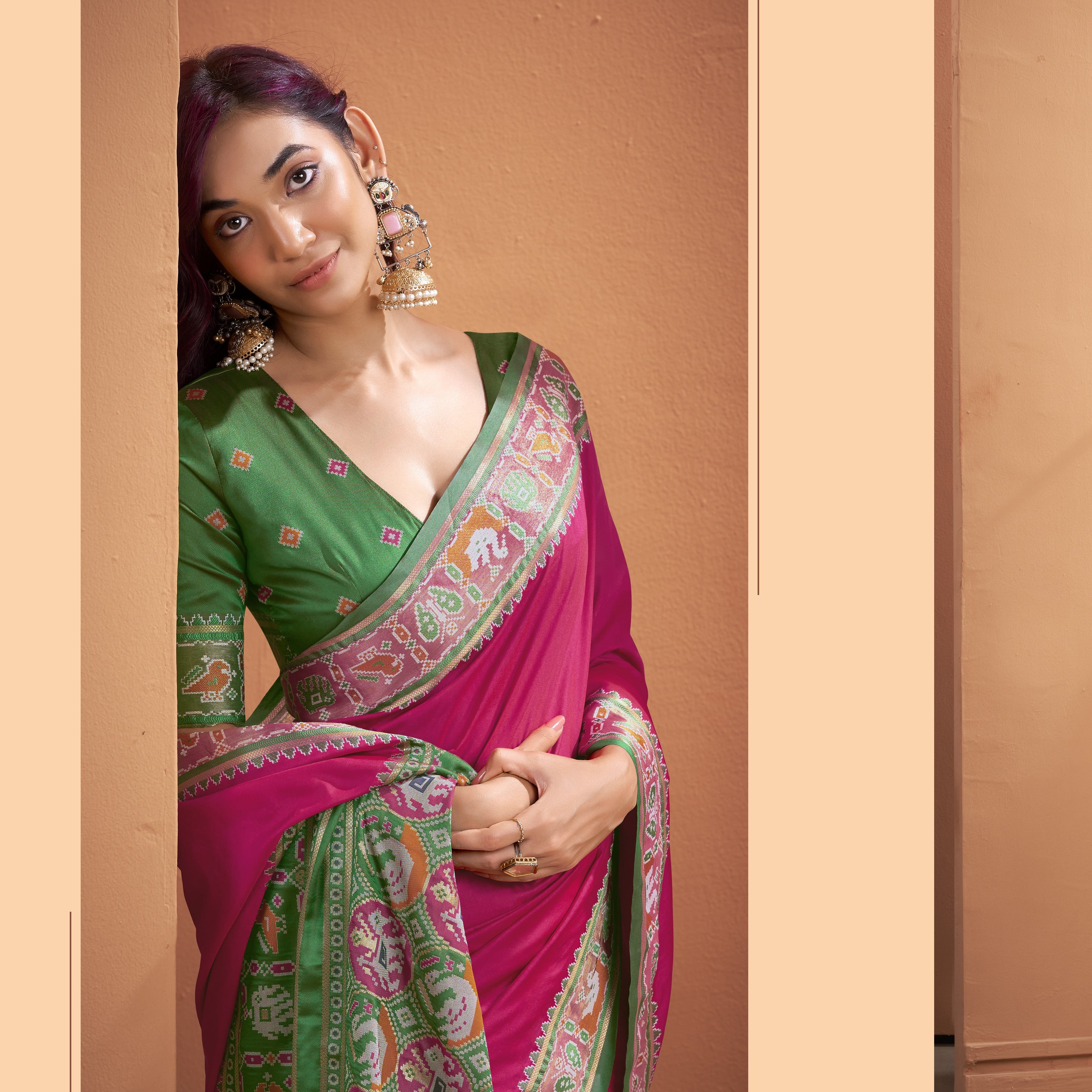 Close-up of Patola Silk ready to wear pocket saree pallu with pink, green, cream, and orange geometric patterns