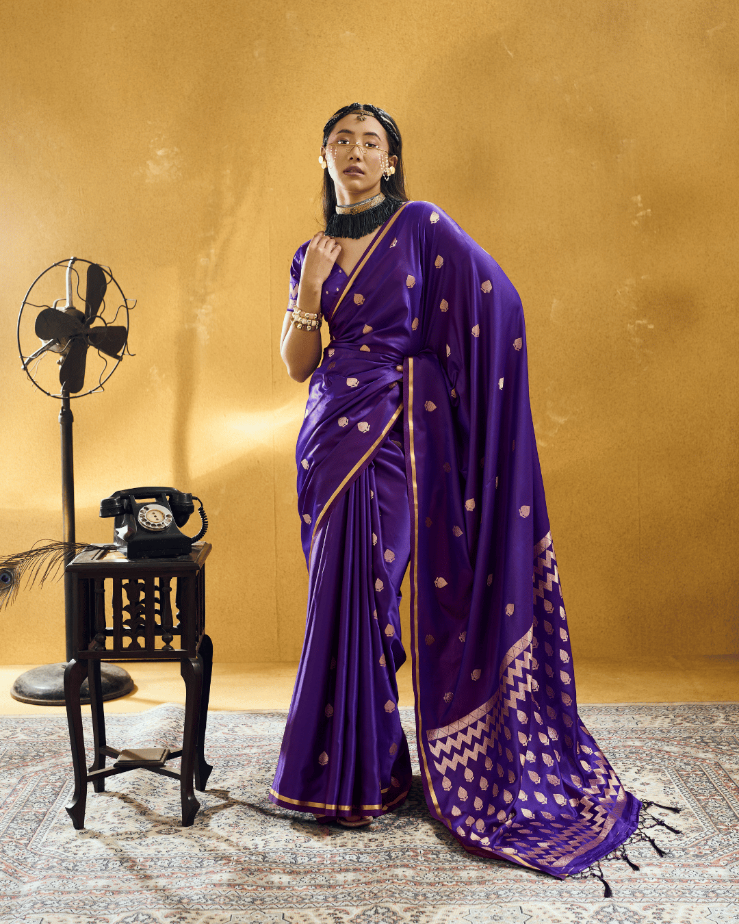 Full-length front portrait of a model in a vibrant violet-purple powerloom satin ready-to-wear pocket saree.