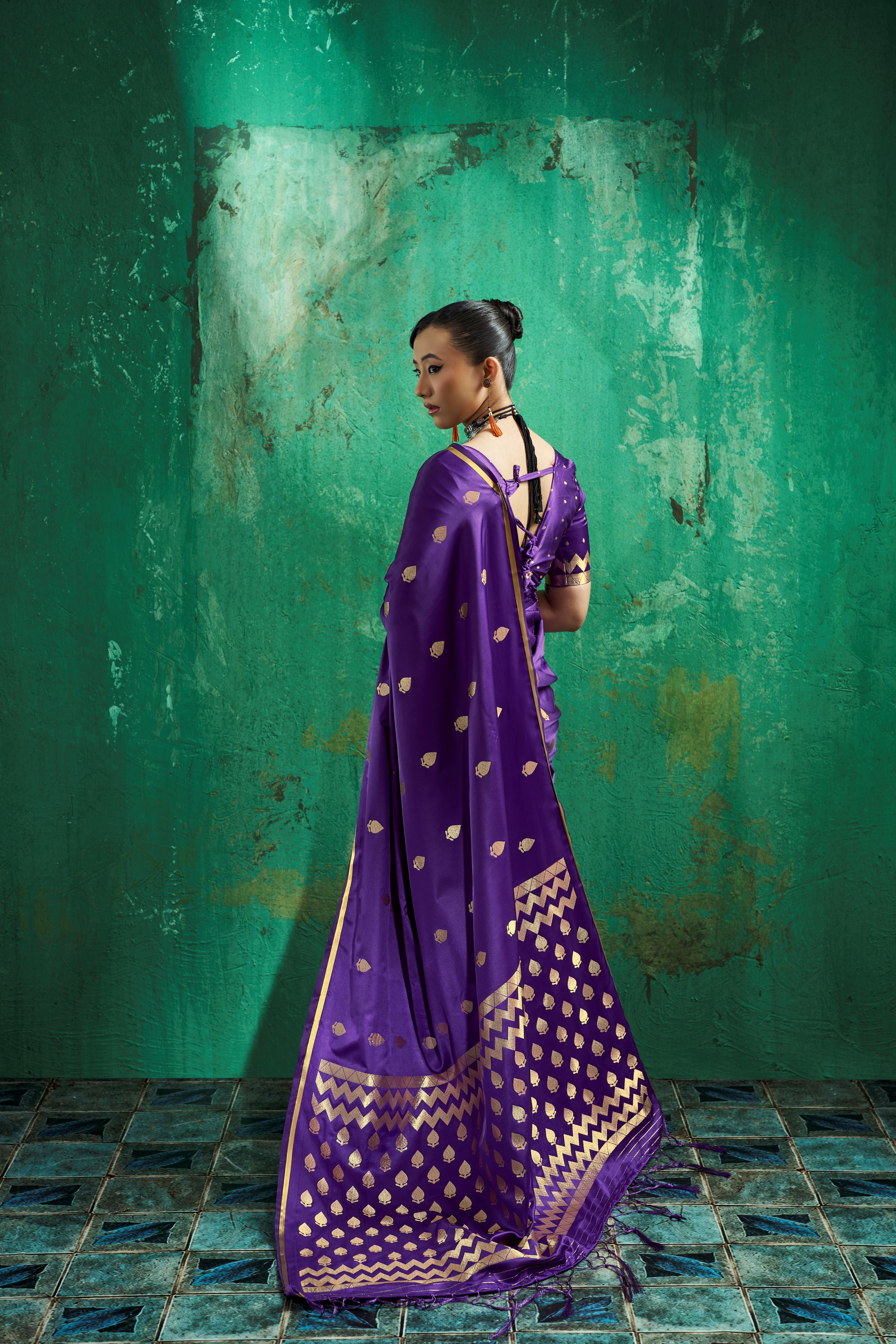 Back view of a pre-draped pocket saree in soft satin royal purple featuring chevron zari pallu and tassels.