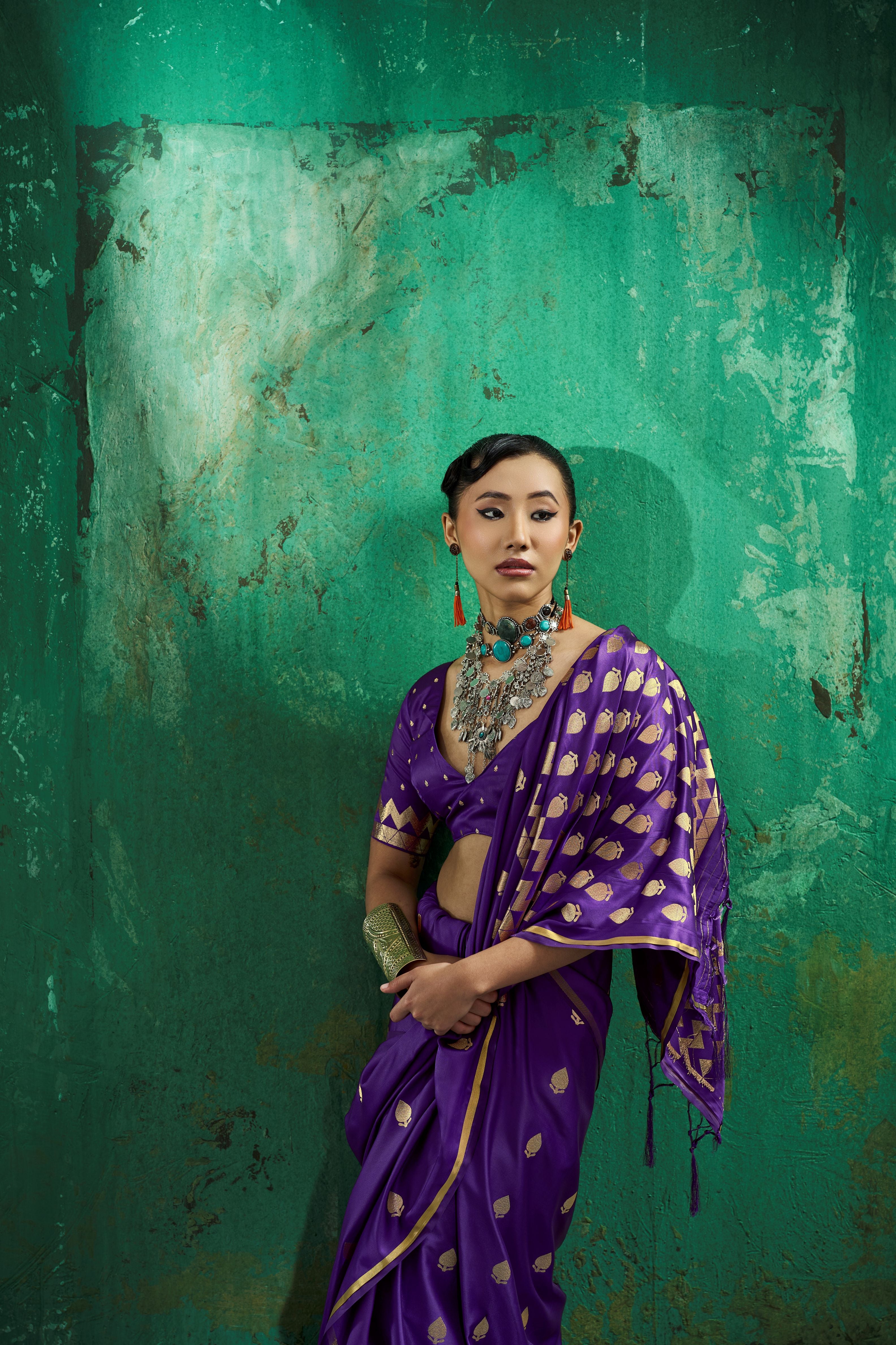 Woman wearing a 1 minute pocket saree in royal purple satin displaying gold leaf zari motifs