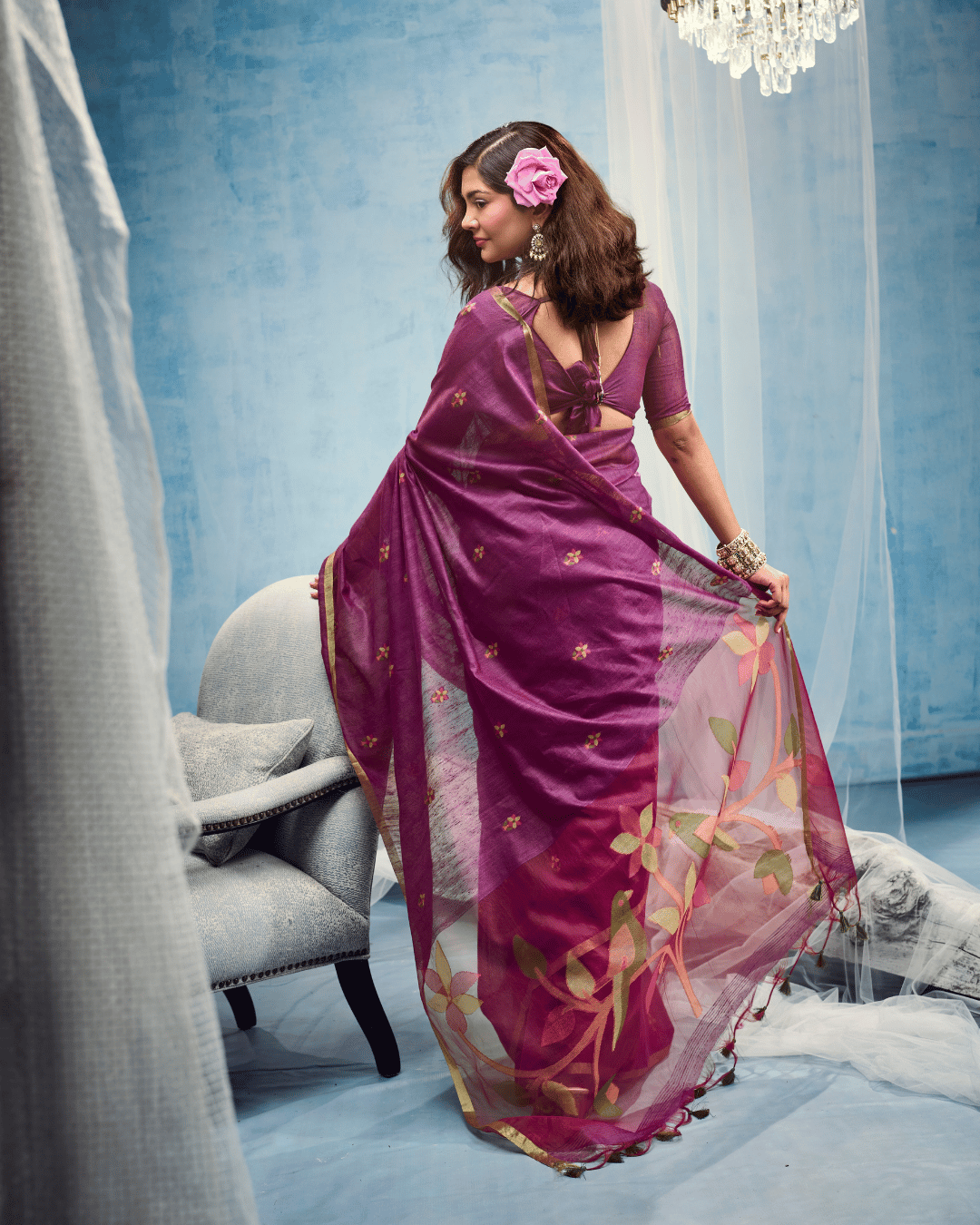 Back view of the sheer berry-toned pallu with green, olive, and peach leaf motifs, highlighting the slim golden border.