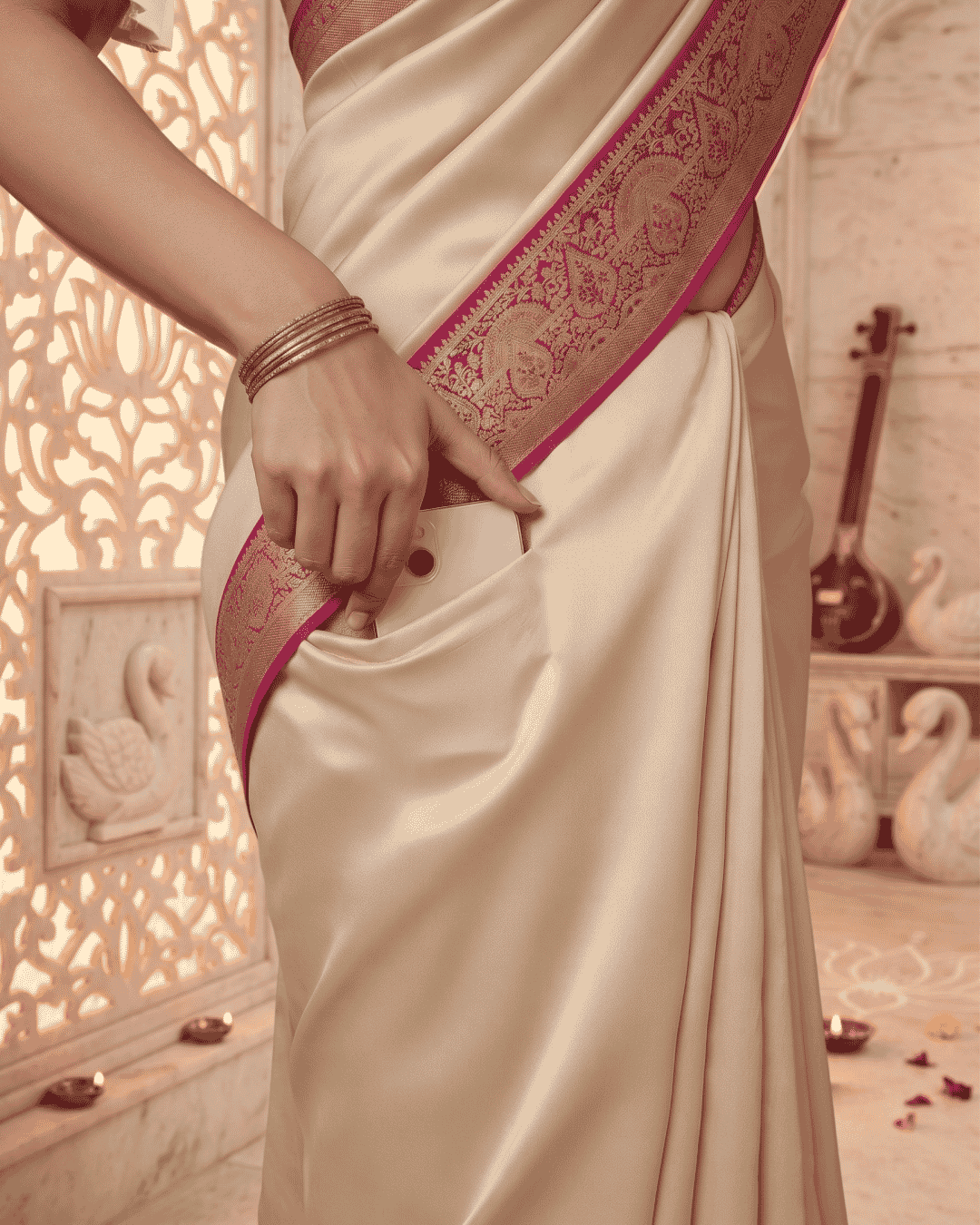 Close-up of the pocket in the soft silk pre-draped saree in shades of beige and pink