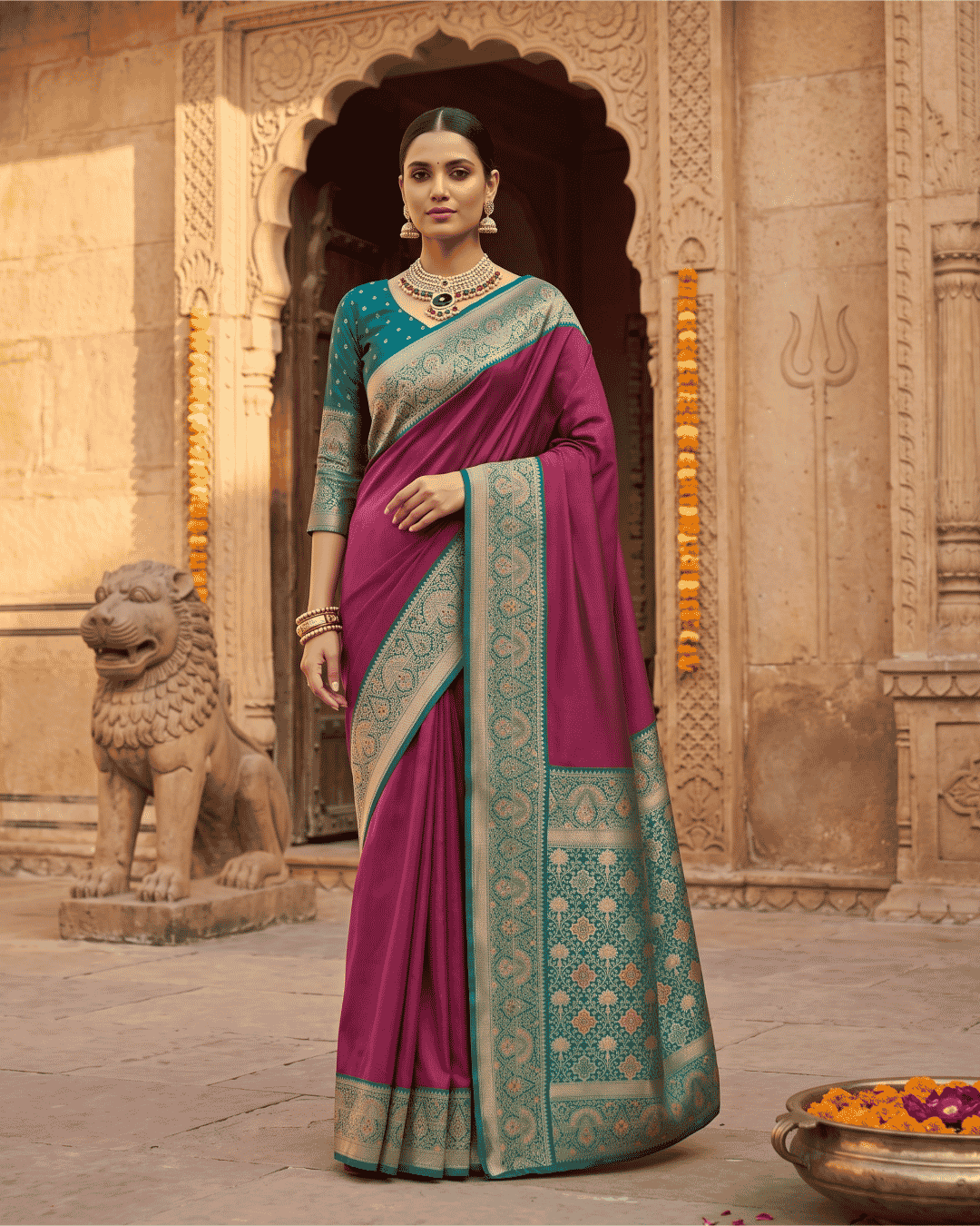 Wine and teal ready-to-wear pocket saree with intricate golden zari patterns.