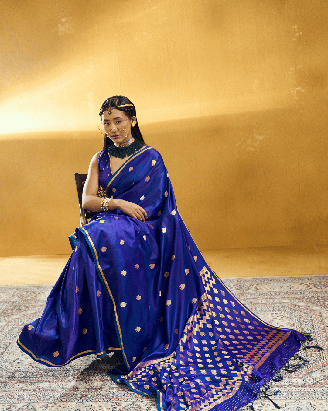 Full-length portrait of a model wearing the Royal Blue Chevron powerloom silk ready-to-wear pocket saree, displaying pre-stitched pleats, champagne-gold leaf motifs, and a geometric chevron pallu.