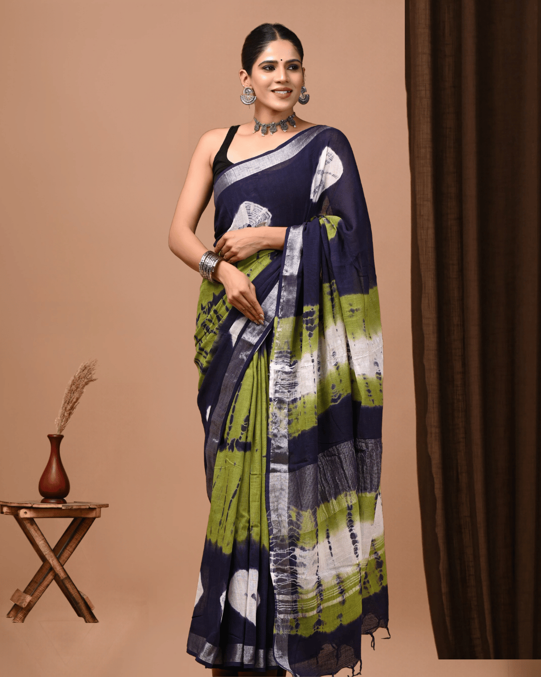 Chromatic Loop linen ready to wear pocket saree in deep navy, olive green and ivory with rounded motifs and a layered striped pallu, suited for brunches, dinners and intimate celebrations.