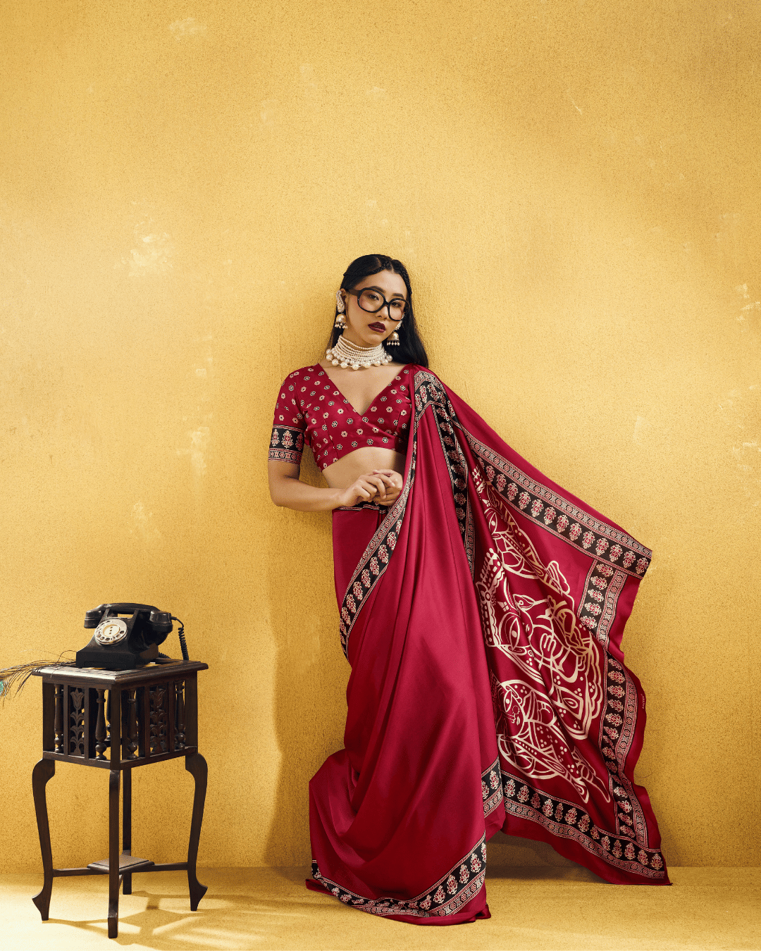 Deep wine ready-to-wear pocket saree featuring black patterned borders and an open pallu adorned with large ivory folk-art motifs.