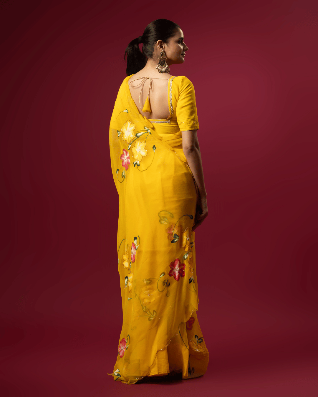 Back shot of the fresh floral grace chiffon ready to wear pocket saree featuring floral vines in yellow, green, and pink.