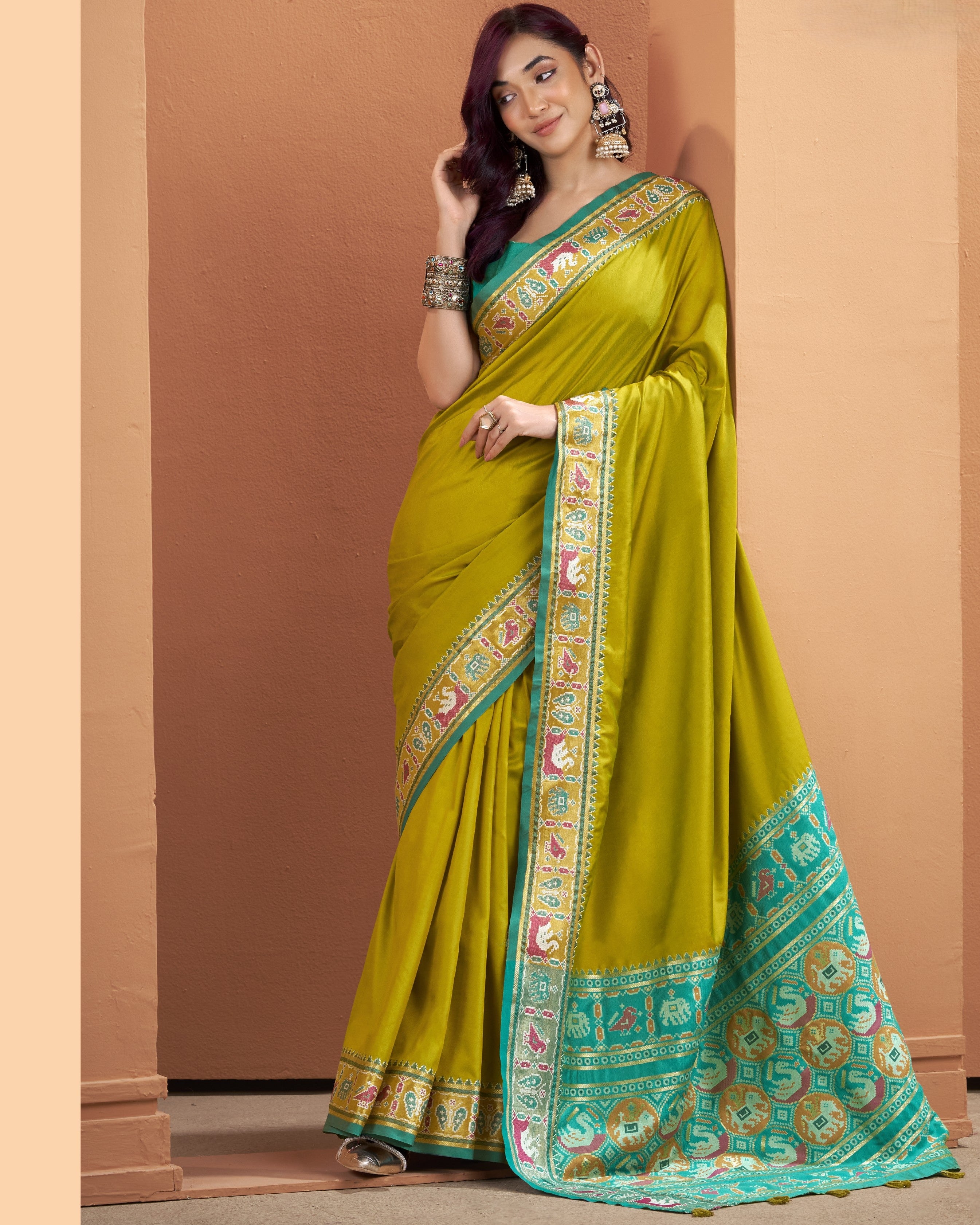 Olive yellow Patola Silk ready-to-wear pocket saree with a multicoloured patterned border and teal pallu.