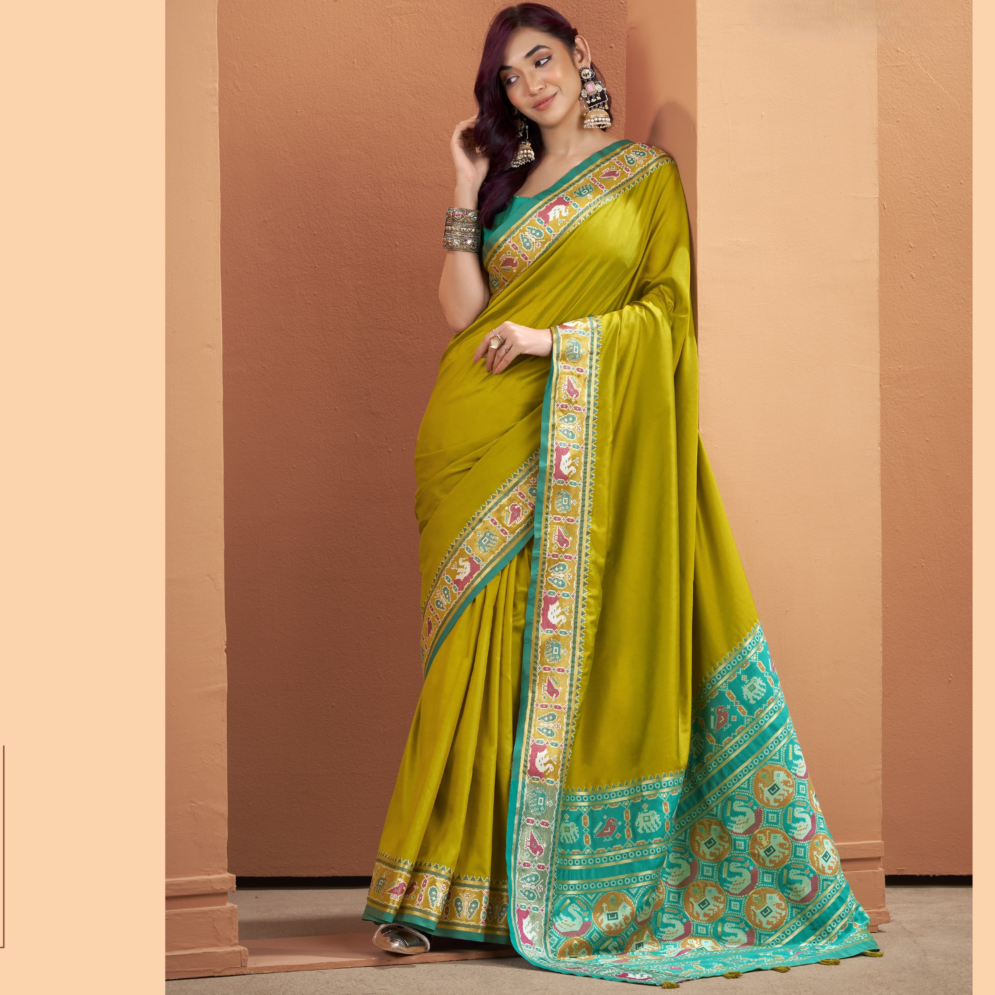 Olive yellow Patola Silk ready-to-wear pocket saree with a multicoloured patterned border and teal pallu.