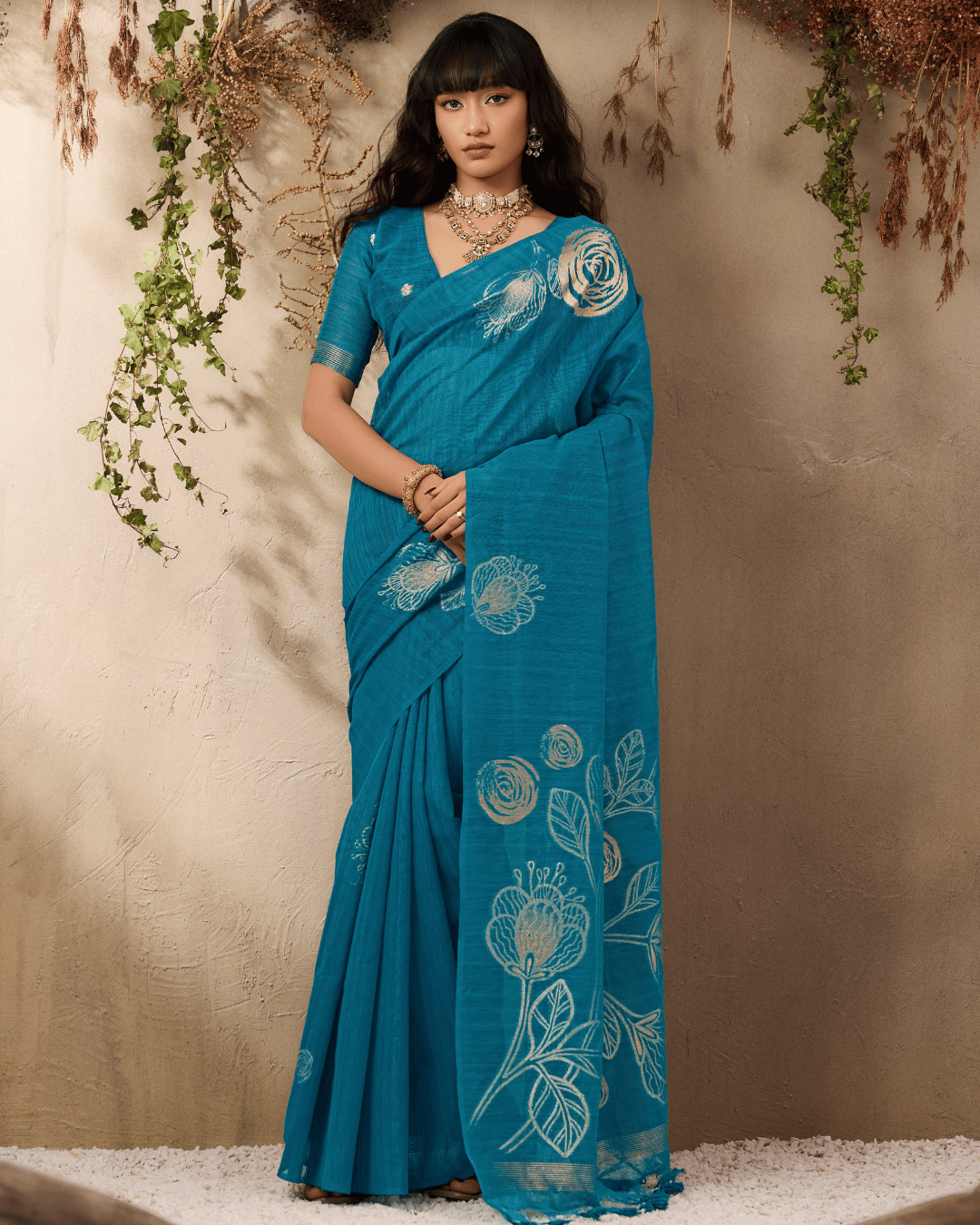 Full-length front portrait, highlighting the balanced layout between the clean teal body and open gold-patterned pallu of the vine and verse ready to wear pocket saree in teal blue.