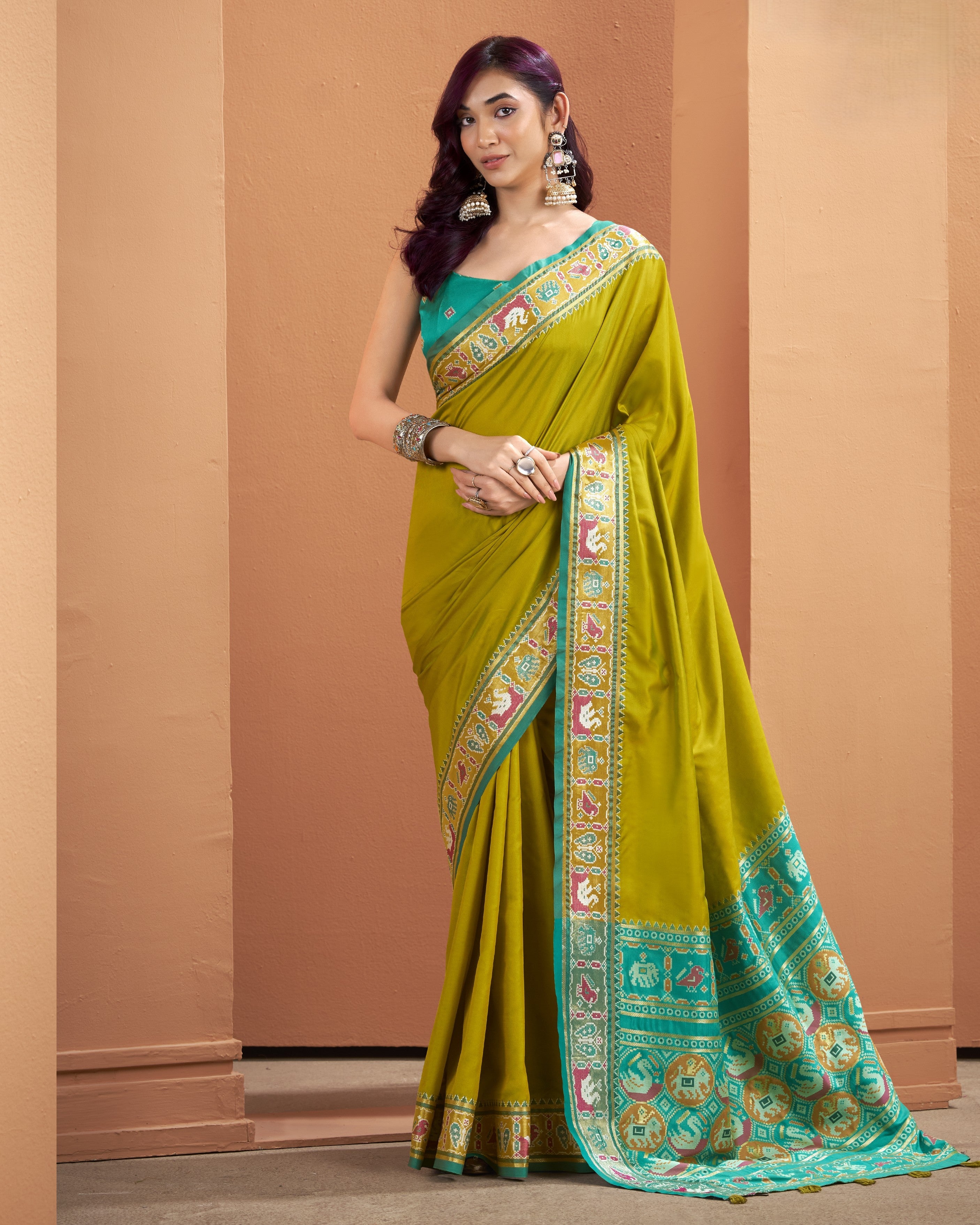 Olive yellow Patola Silk ready to wear saree with pocket with a teal patterned border, statement border, and tassels
