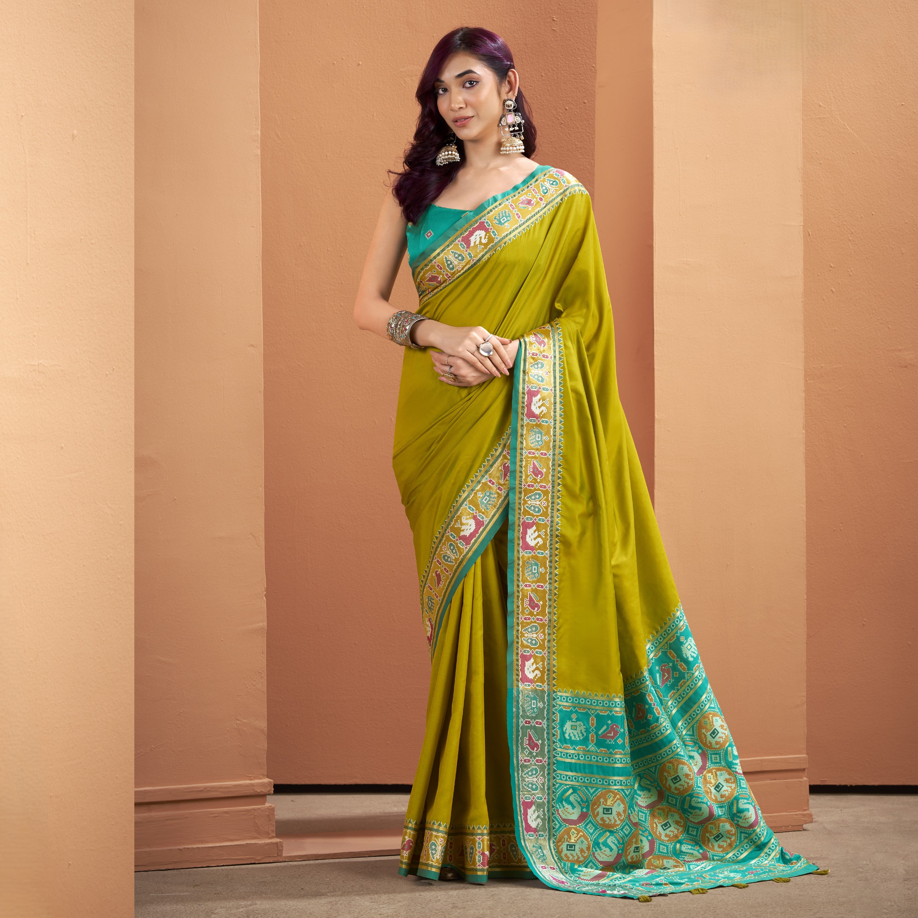 Olive yellow Patola Silk ready to wear saree with pocket with a teal patterned border, statement border, and tassels