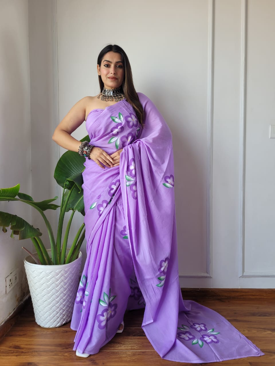 Front shot of the floral drift ready to wear pocket saree with floral details on a lavender backdrop