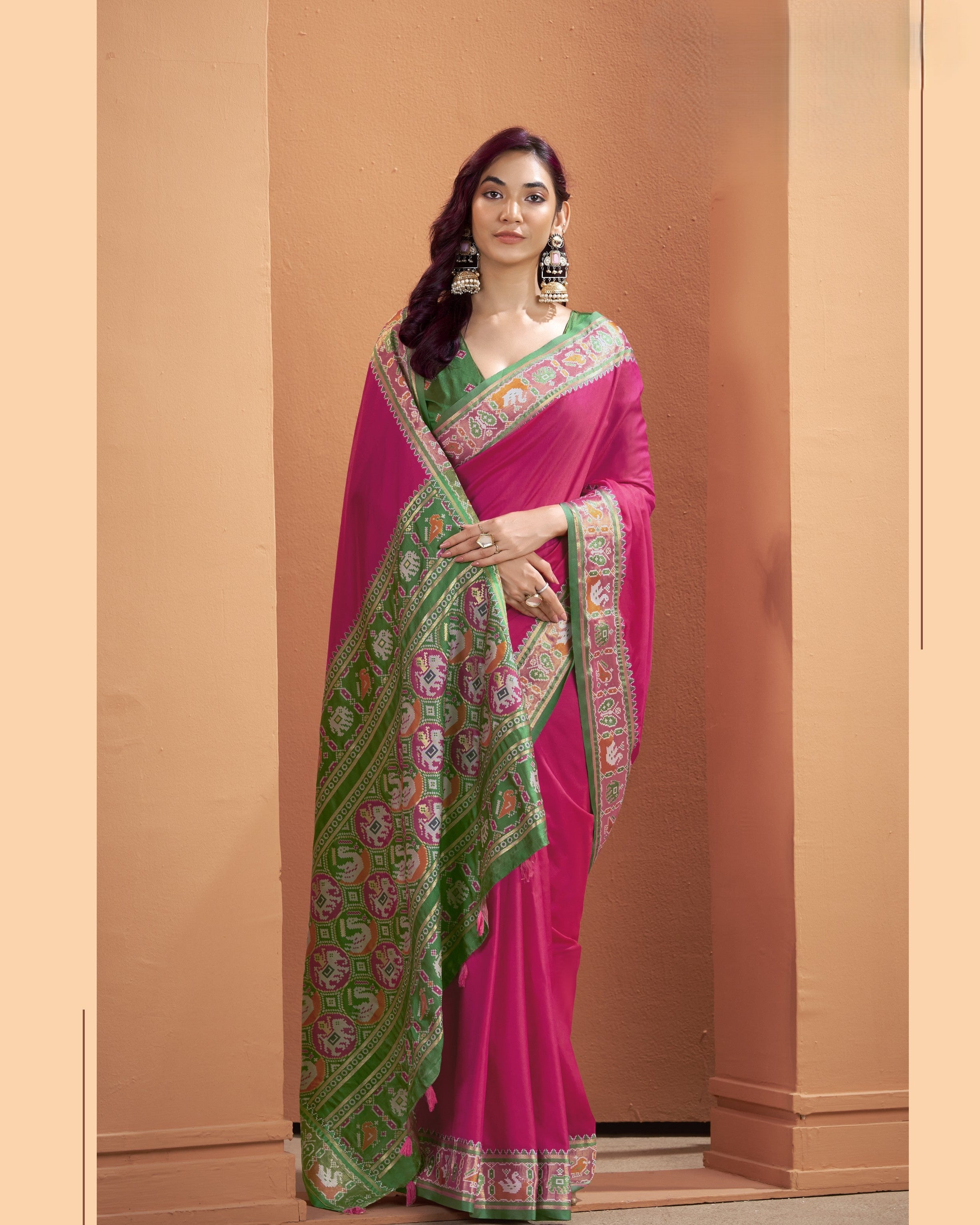 Magenta pink Patola Silk ready-to-wear pocket saree with green patterned border and colourful pallu