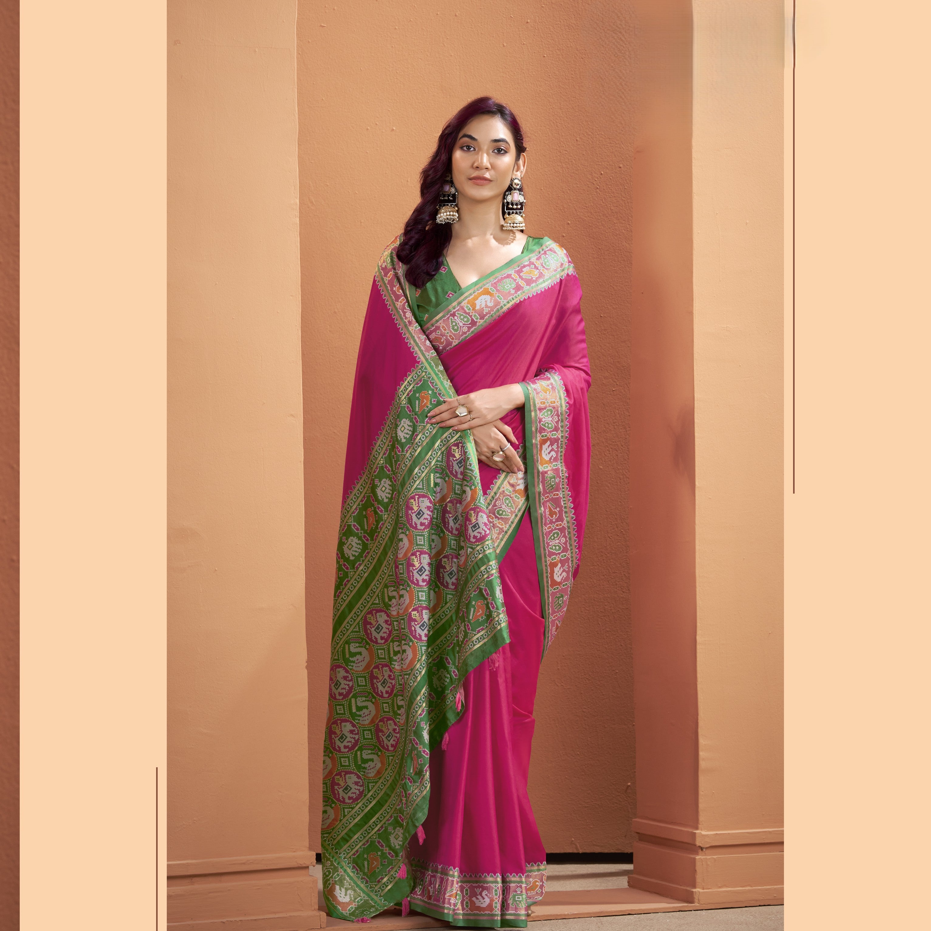 Magenta pink Patola Silk ready-to-wear pocket saree with green patterned border and colourful pallu