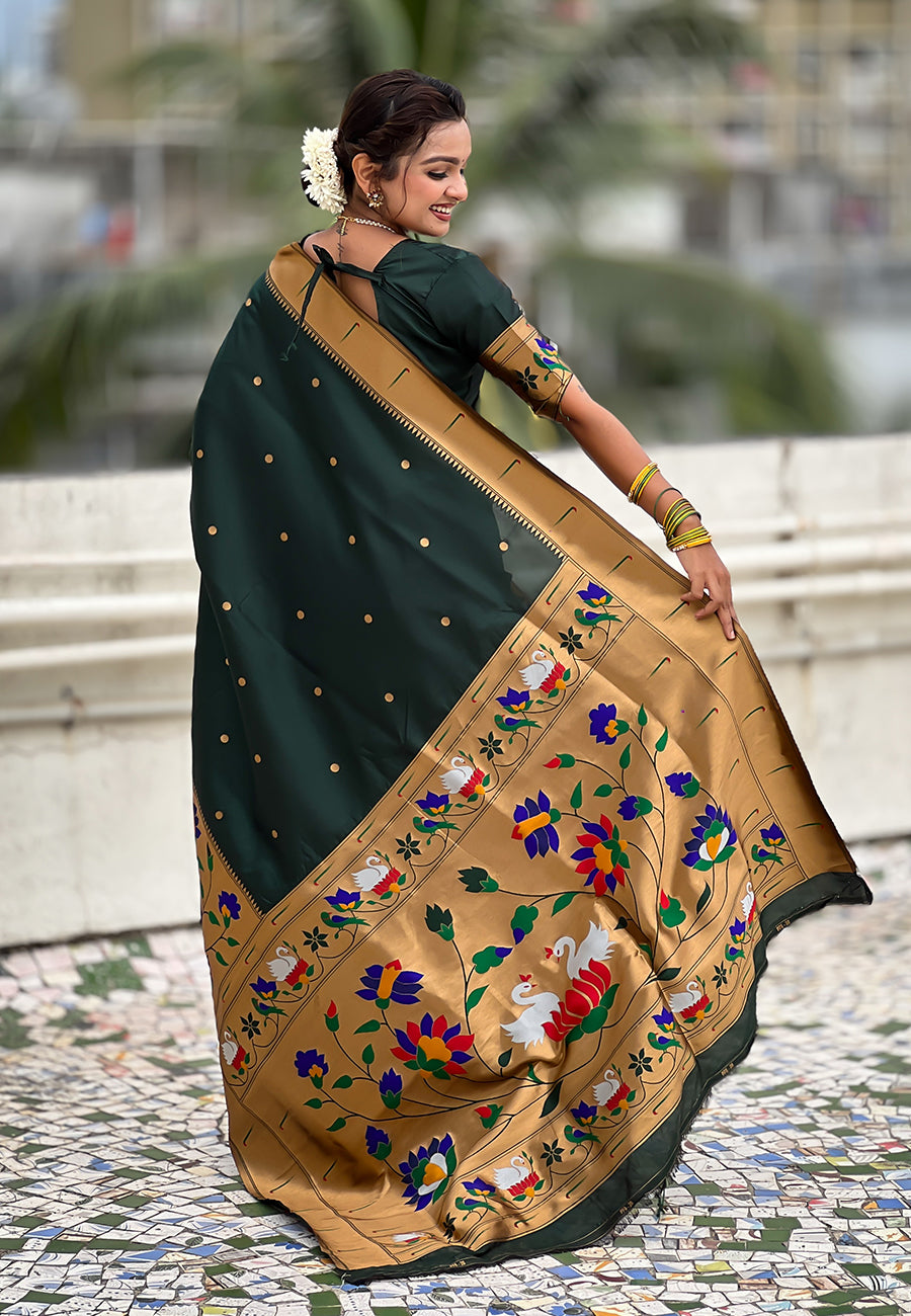 Back view of the detailed gold-toned floral and swan-motif pallu of a deep green ready-to-wear Paithani saree.