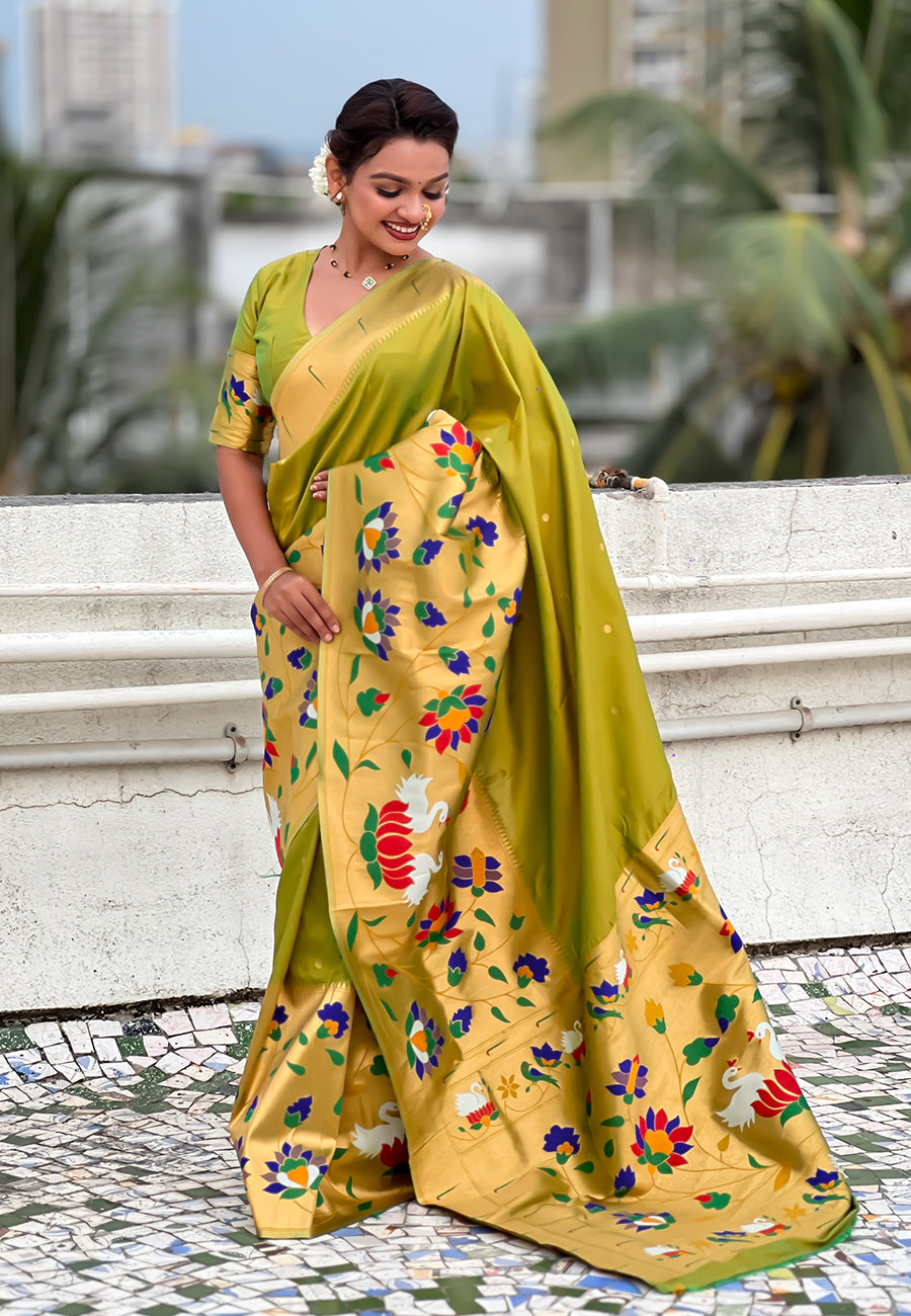 Full-length shot showing the flow and drape of a mehendi green ready-to-wear pocket saree with pre-arranged pleats and an intricate golden pallu.