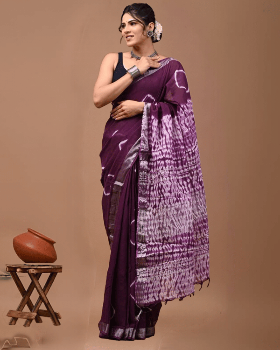 Jamuni Leher deep plum linen ready-to-wear saree with ivory linear motifs, silver-toned border, patterned pallu and tassel detailing.