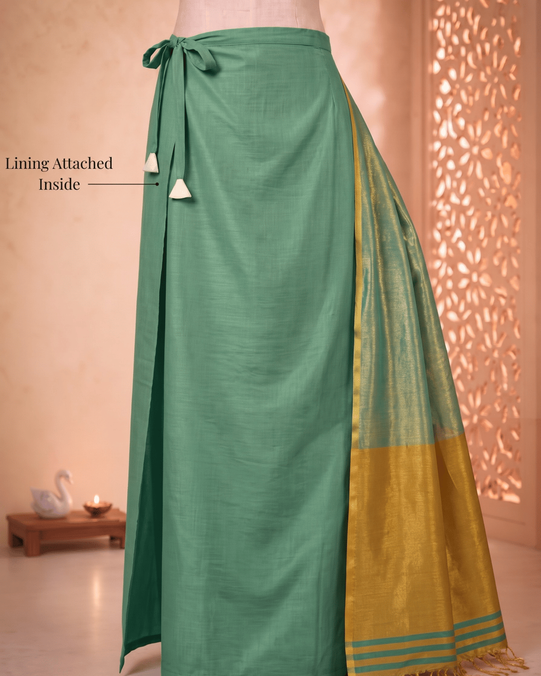 Attached lining and adjustable drawstring of the green luminous glow tissue silk ready to wear pocket saree.