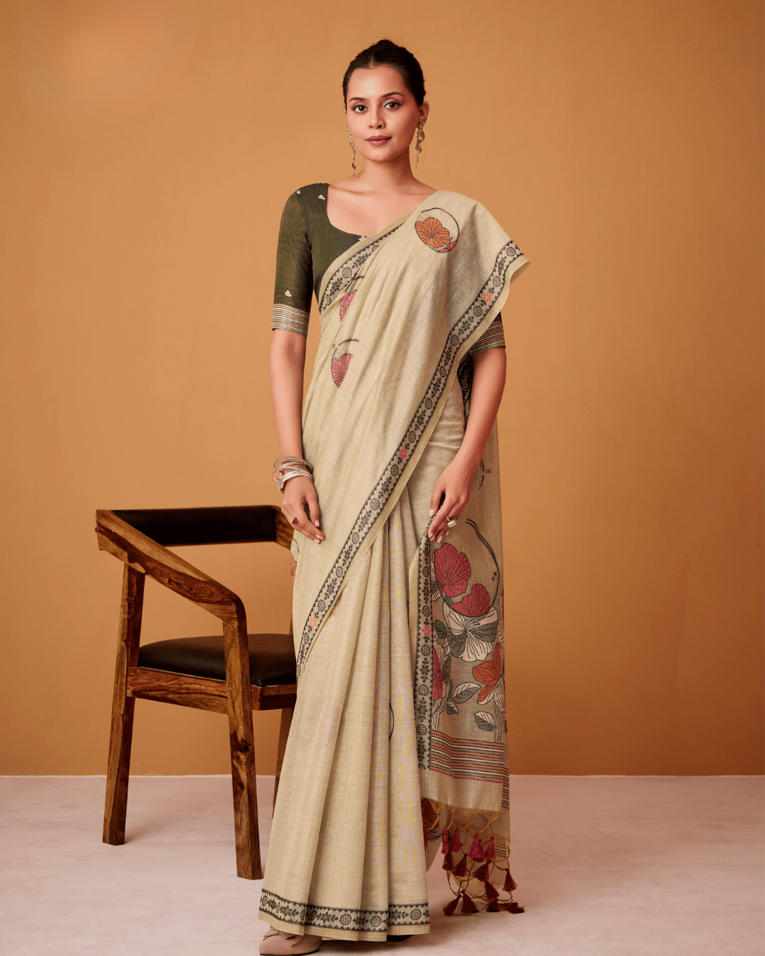 Full-length front portrait of the model in the Petal Vines cotton ready-to-wear pocket saree, displaying pre-arranged pleats and a cascading floral pallu finished with deep rust tassels.