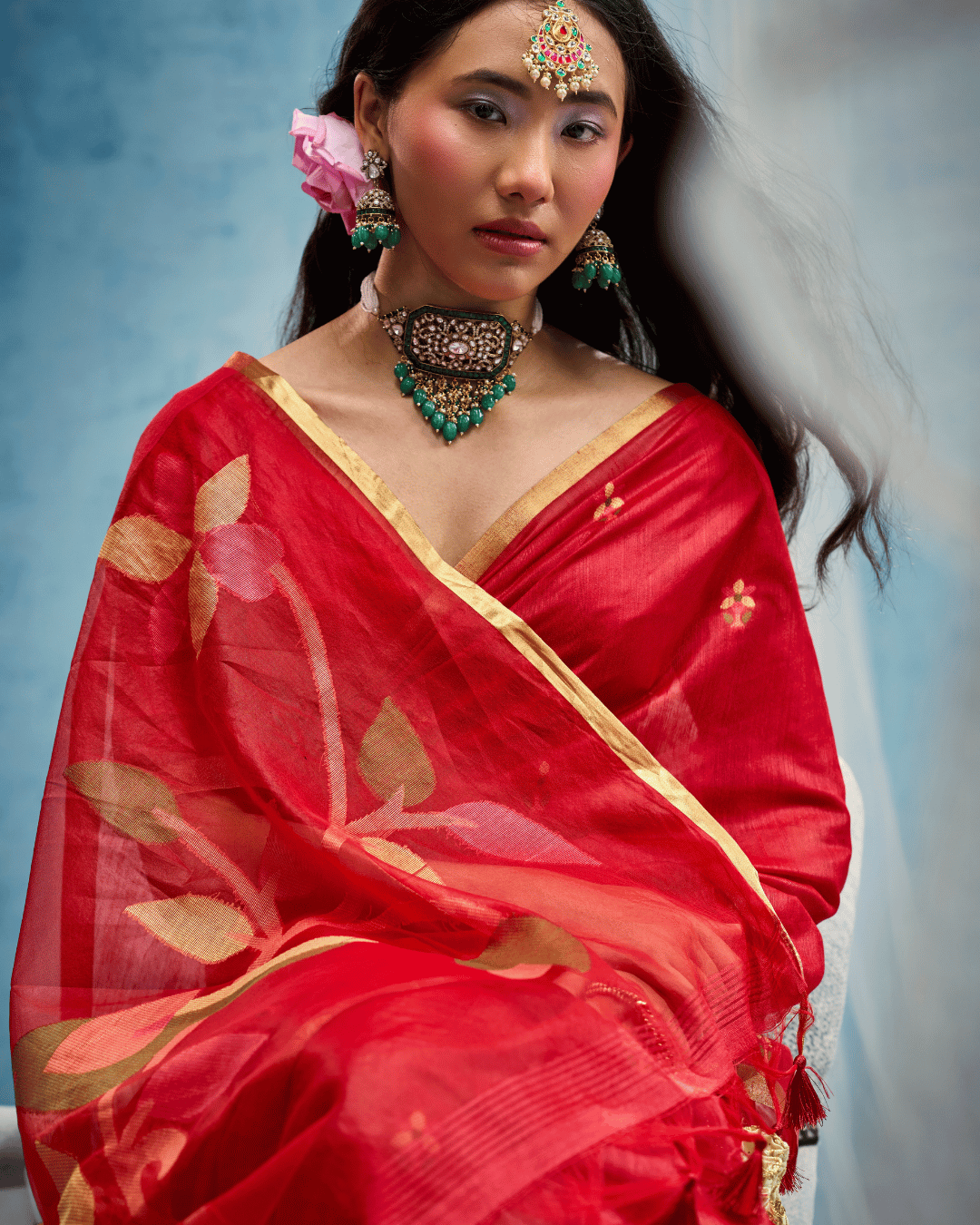 Close-up shot highlighting the fine munga-cotton texture, thin gold border, and large woven leaf-and-bird motifs on the draped pallu.