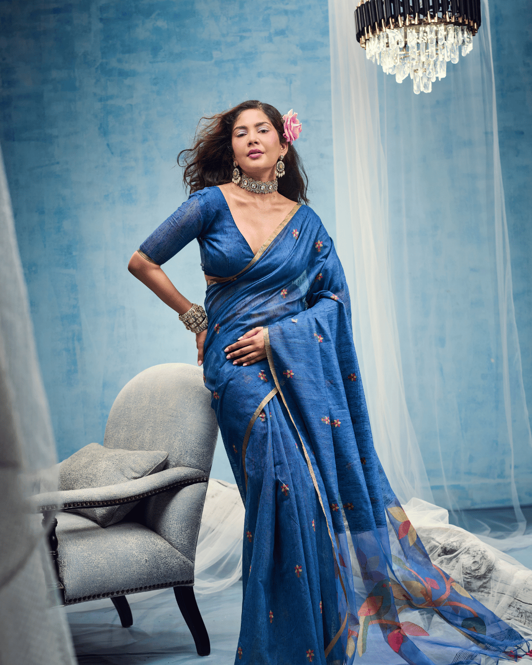 Royal blue pre-draped pocket saree, showcasing the neat pre-set front pleats, slim gold border trim, and scattered small floral motifs across the drape.