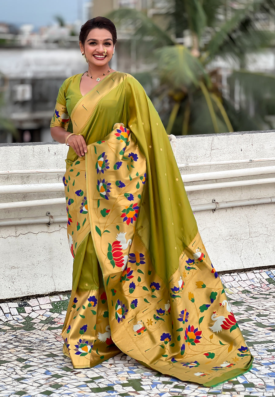 Full-length shot of a mehendi green ready-to-wear Paithani saree with pocket featuring a rich golden floral pallu.