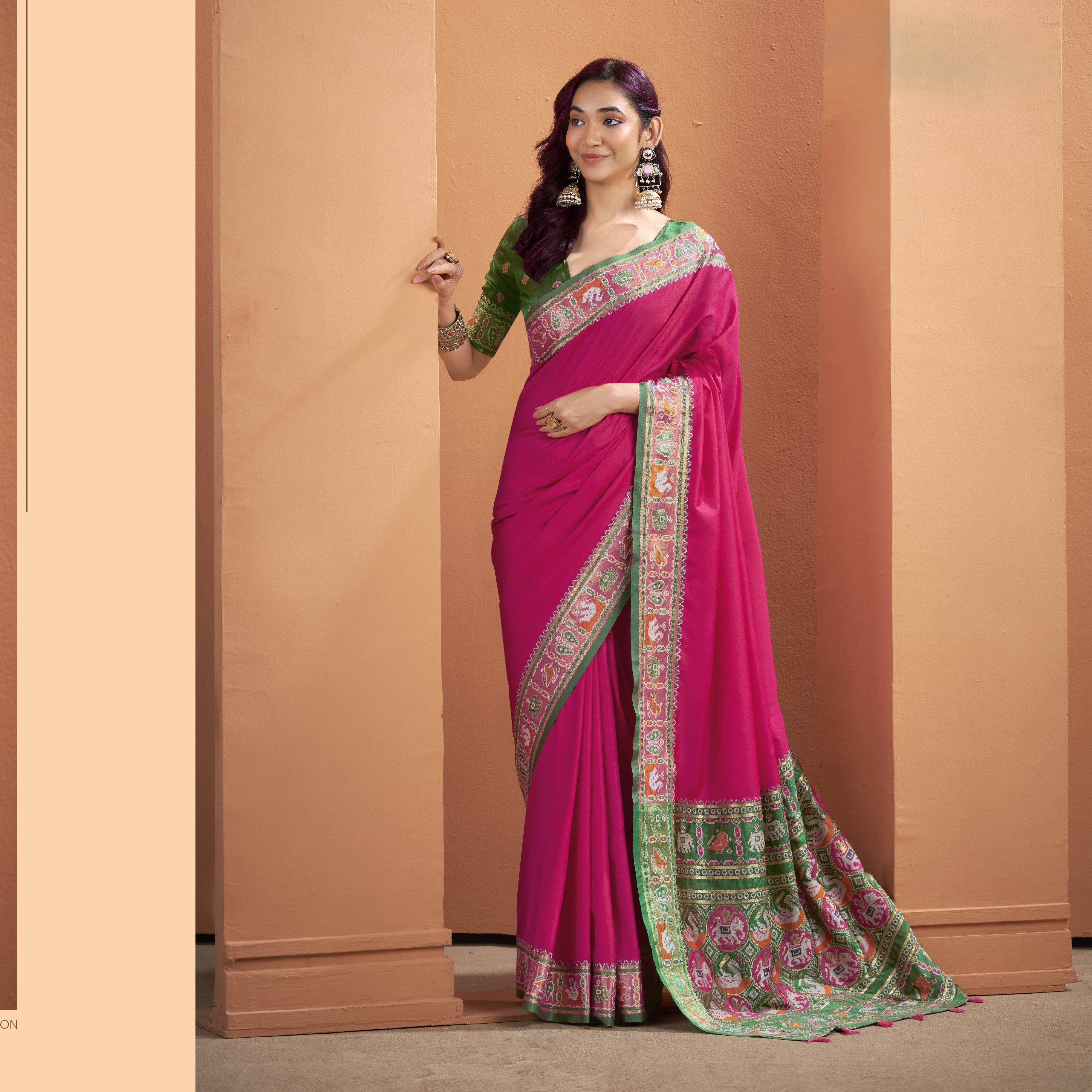 Magenta pink ready to wear pocket saree with detailed green pallu featuring geometric patterns and tassels