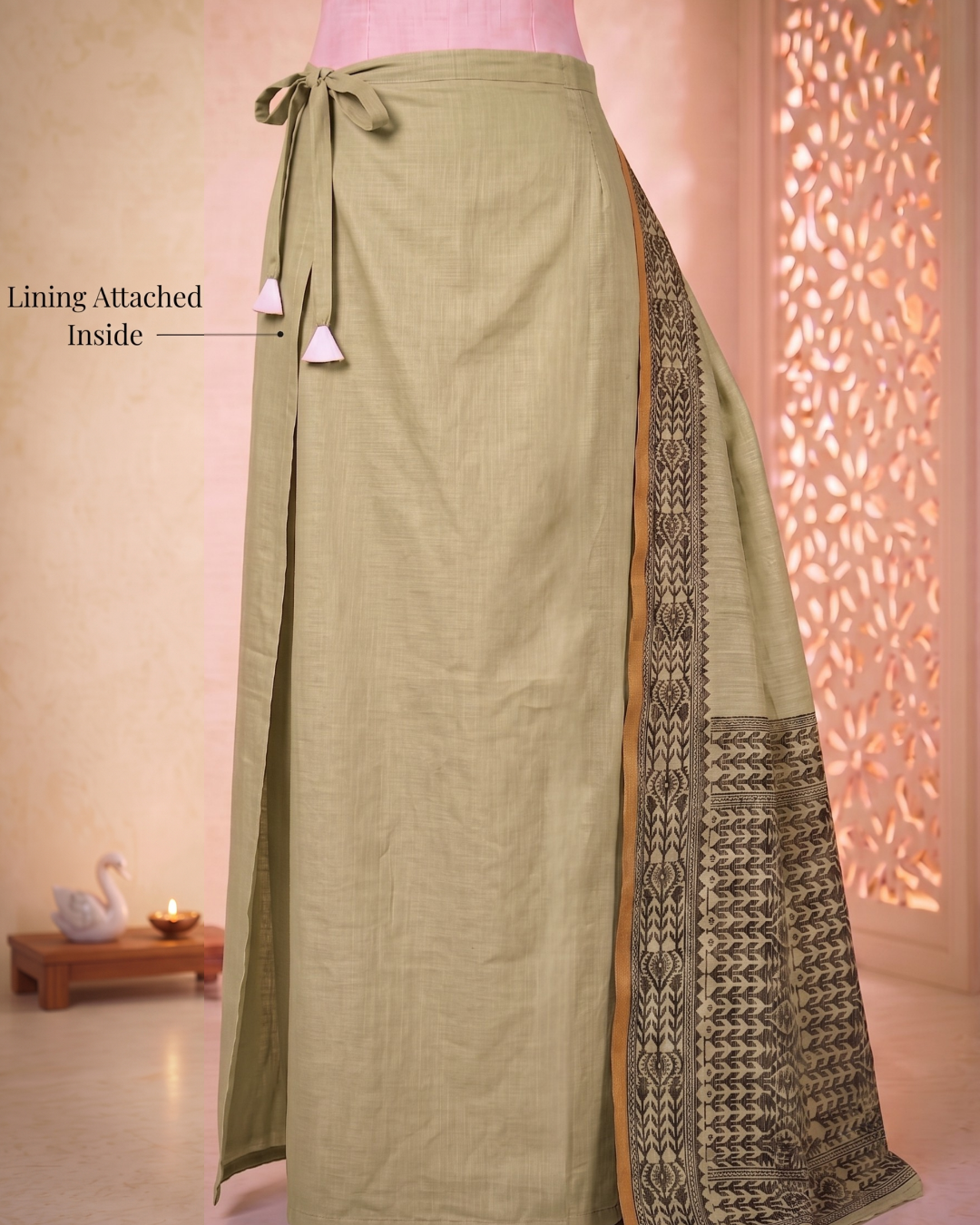 Built-in lining and the adjustable drawstring of the meher muted pastel green pre-stitched pocket saree.