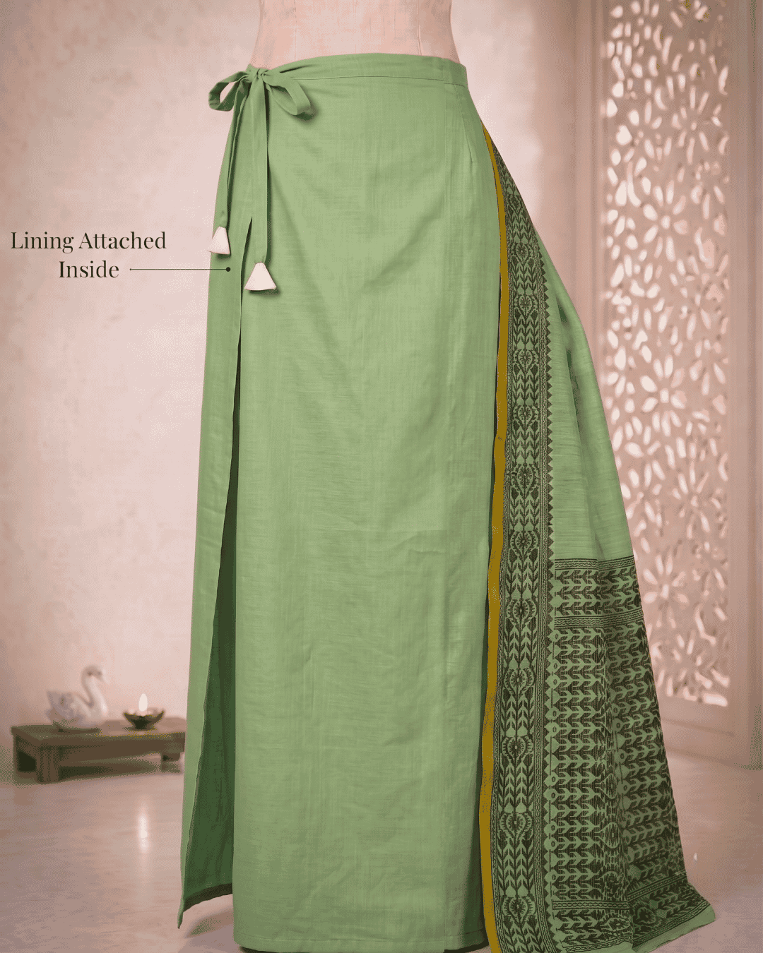 Detailed side view of the built-in lining and the adjustable waist drawstring of the meher sage green 15-second pocket saree.