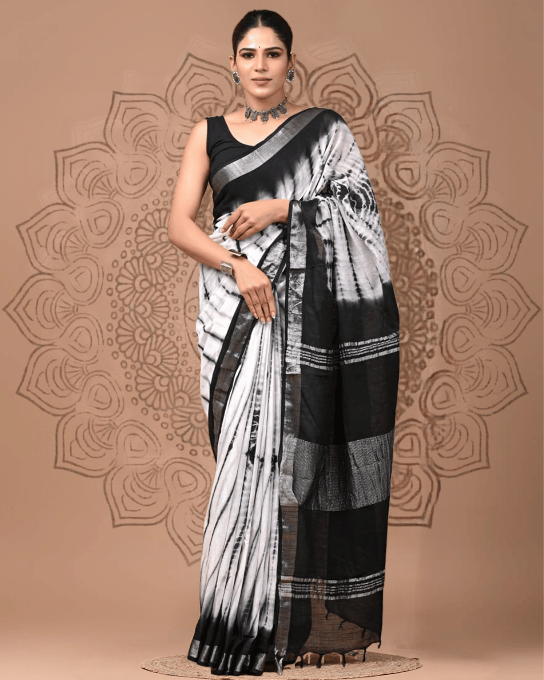 Vellum black and white linen ready-to-wear pocket saree featuring abstract charcoal-grey streaks, a bold black pallu, fine linear detailing and dark tassel edging.