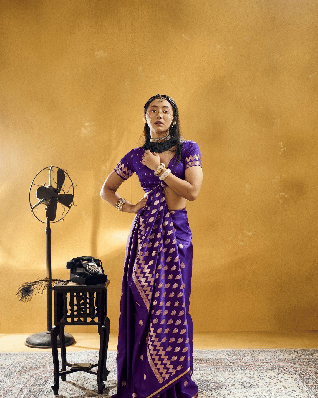 Full-length portrait of a model wearing the vibrant violet-purple pre-stitched pocket saree, displaying pre-arranged pleats, metallic gold border trim, and a cascading chevron pallu.