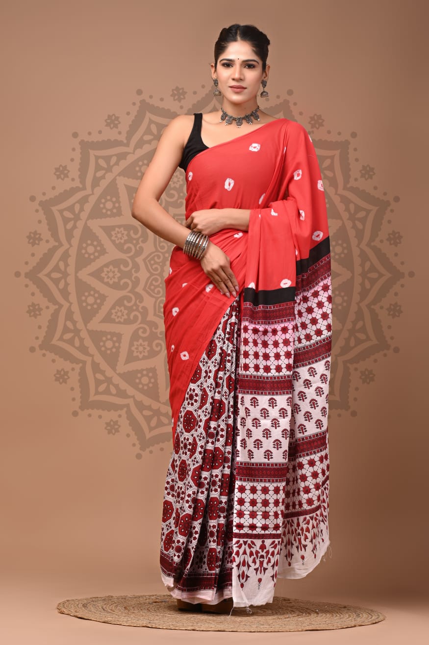 Full-length shot of a model in the Crimson Folk Mul Cotton ready-to-wear pocket saree, featuring a bright red body with scattered white motifs, pre-stitched pleats with a deep maroon block-printed lower panel, and a geometric floral pallu.